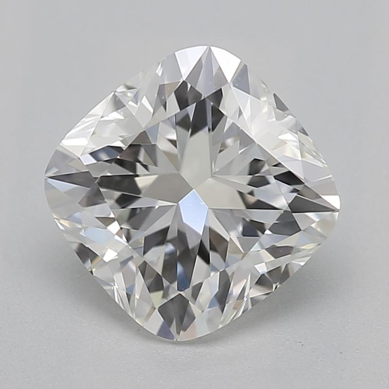 Handcrafted in New York, a stunning diamond ring that exemplifies timeless beauty and sophistication, featuring a captivating cushion center stone weighing 1.04 with a striking H and clarity of VS1. Its classic three-stone design is enhanced by two