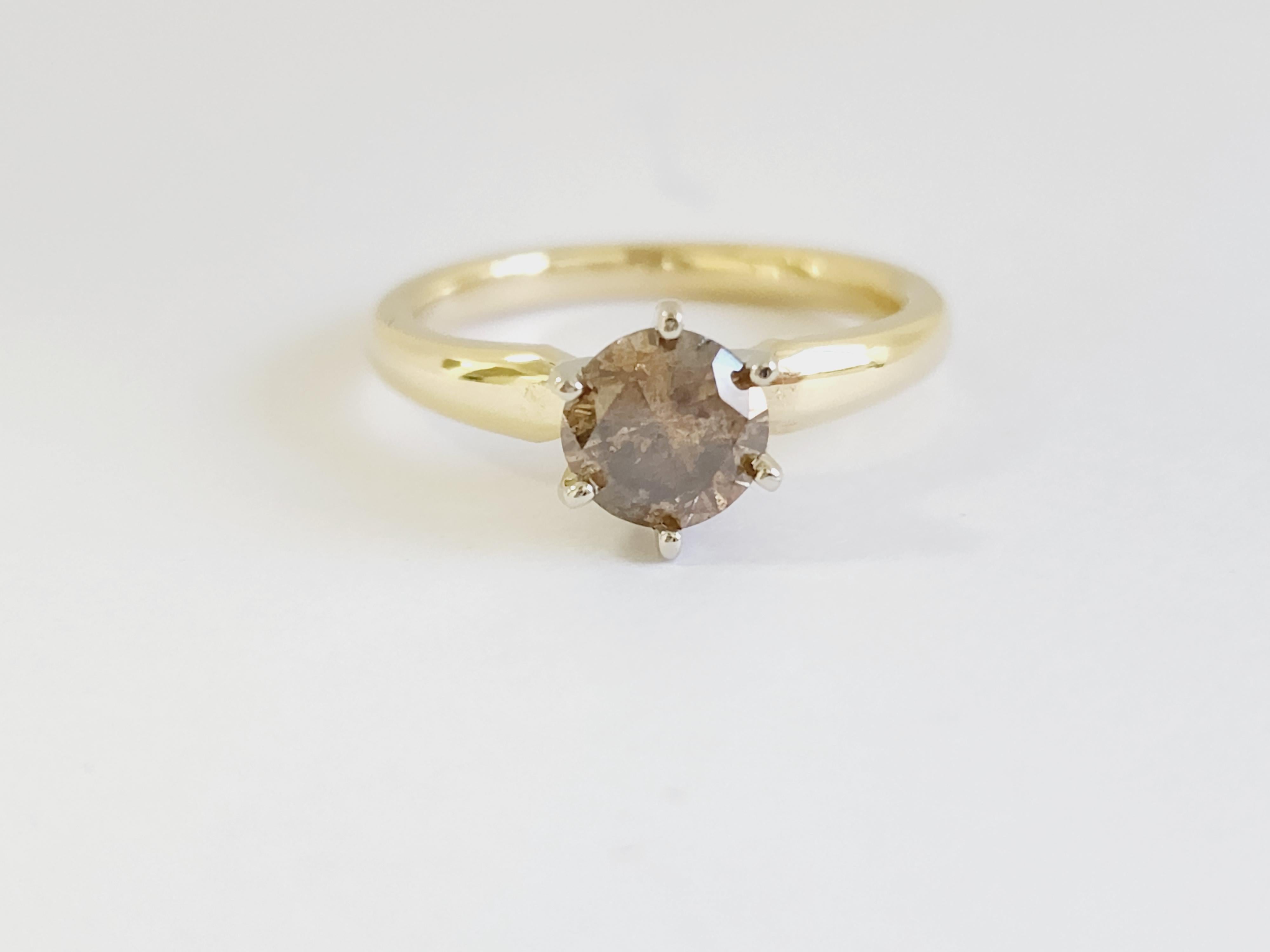 Natural fancy dark yellowish brown round diamond weighing 1.05 carats. Set on 6-prong 14K yellow gold.
Ring size: 6.75
