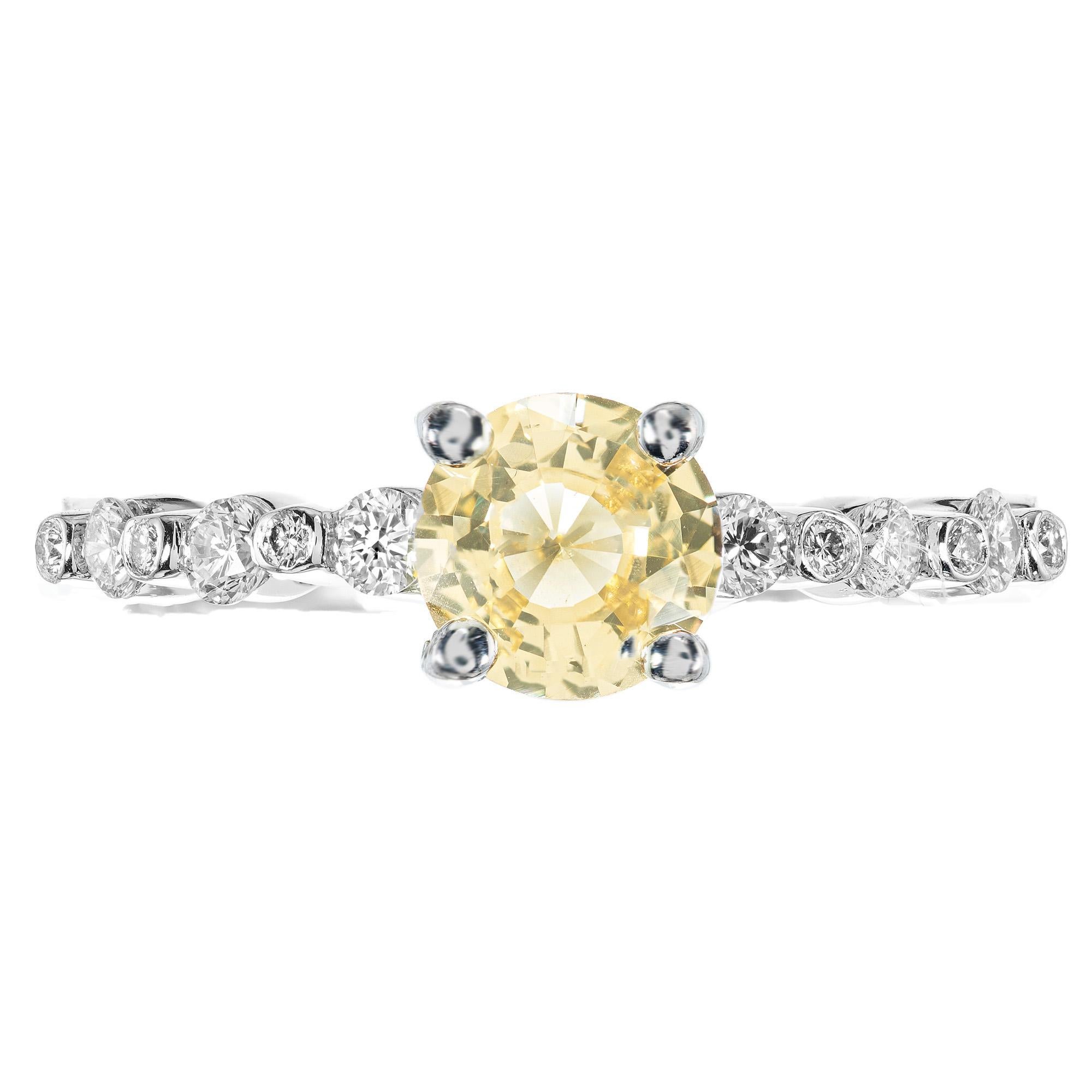 Natural fancy yellow Sapphire Diamond platinum Engagement Ring. The center stone is a GIA certified 1.05ct brilliant yellow round sapphire. Certified as natural, no heat. exuding a warm and vibrant hue. Paired beautifully with 12 bezel tube set