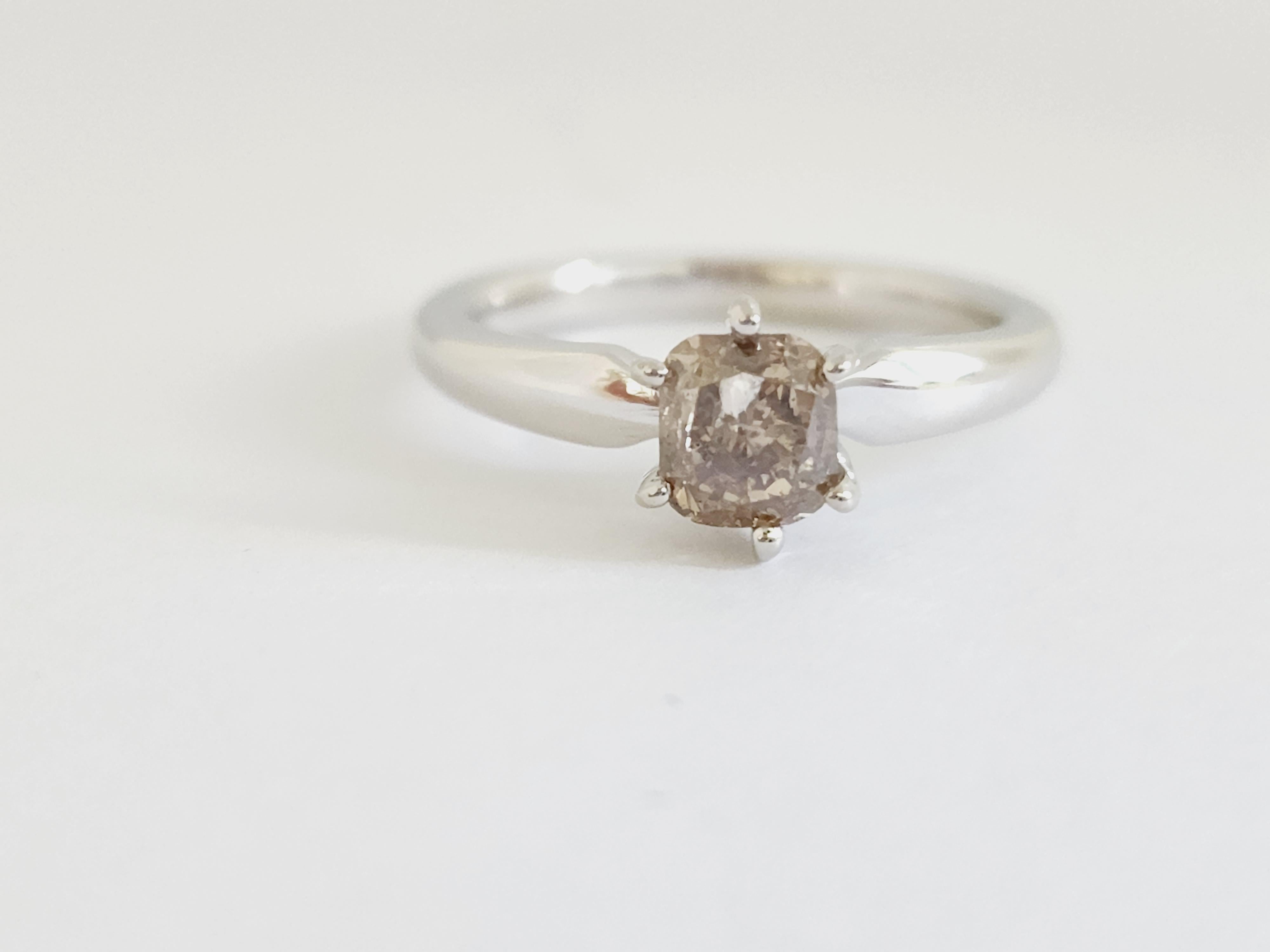GIA Natural fancy dark brown cushion diamond weighing 1.08 carats. Set on 6-prong 14K white gold. 
Ring size: 6.75