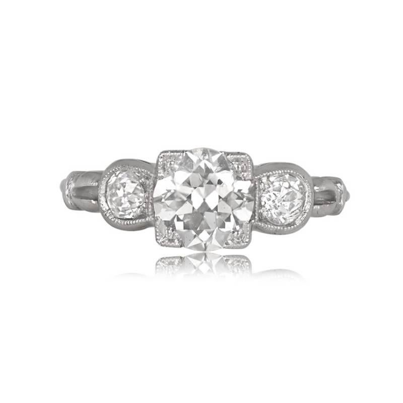A stunning 1.09-carat old European cut engagement ring accented by diamonds on each side, embellished with intricate engraving along the sides. The center diamond is GIA-certified, weighing 1.09 carats, K color, and VS2 clarity. A copy of the GIA