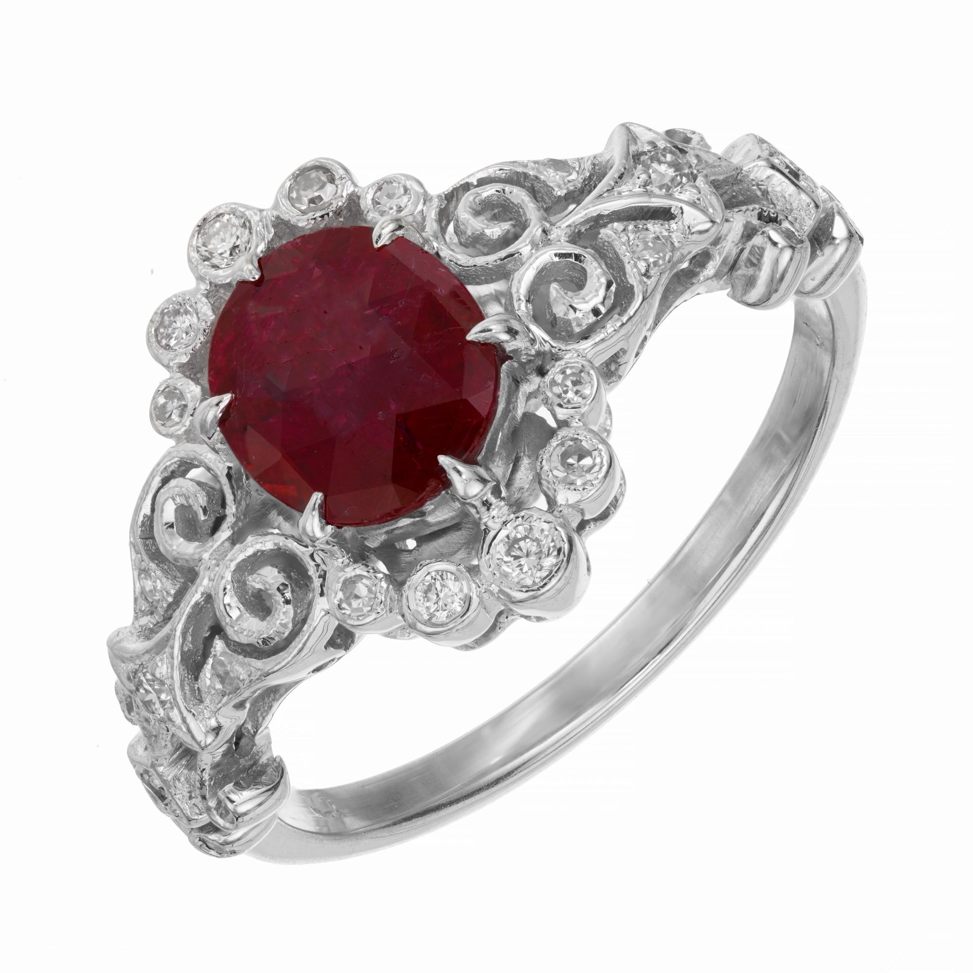 Vintage inspired Ruby and diamond engagement ring. GIA certified simple heat only, oval 1.15 carat ruby center stone mounted in a unique handmade 18k white gold setting with a diamond halo and filigree sides. 24 round accent diamonds complete this