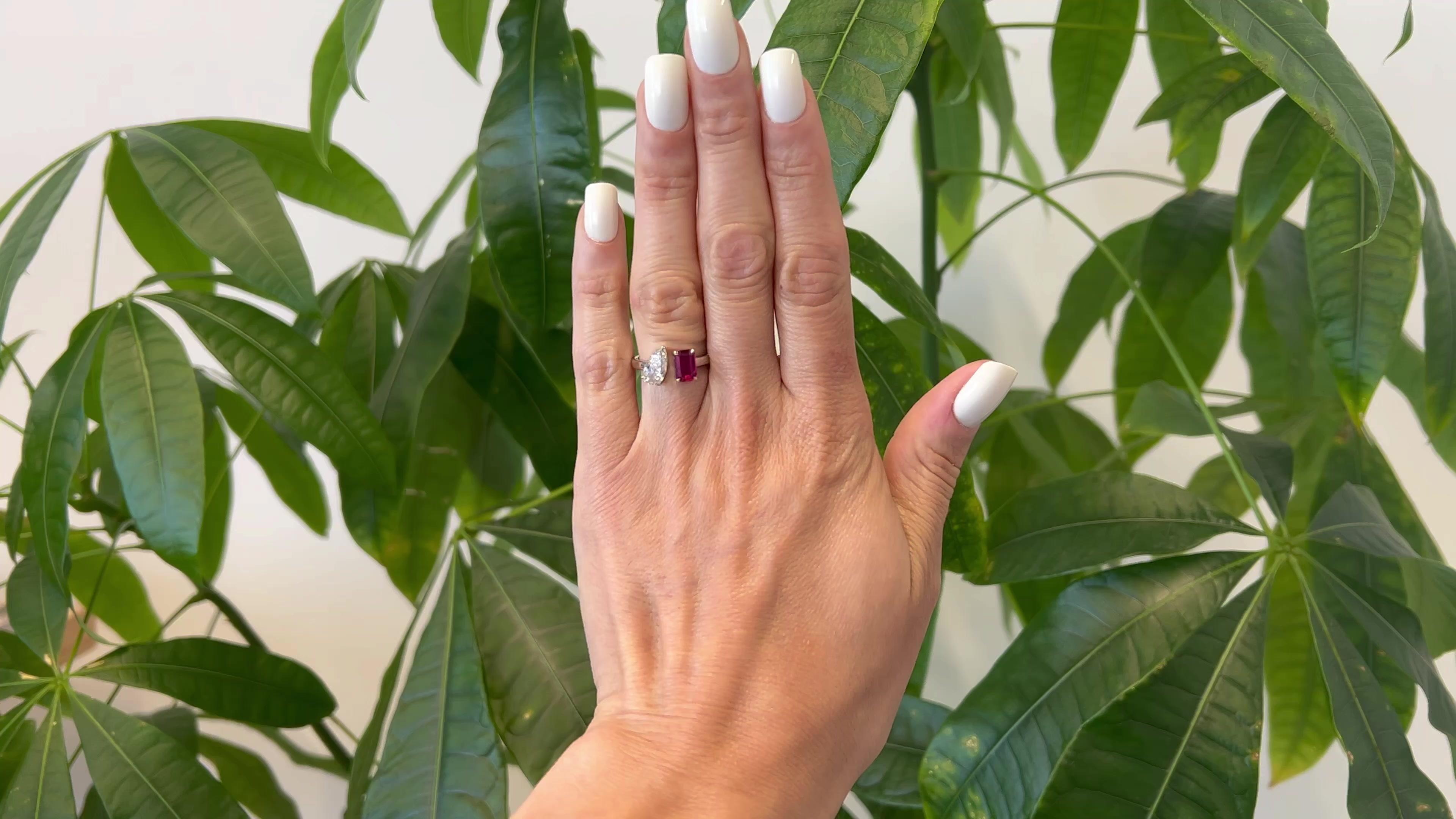 One GIA 1.15 Carat Pear Cut Diamond and Ruby Platinum Toi et Moi Ring. Featuring one GIA pear cut diamond of 1.15 carats, accompanied with GIA #6465333736 stating the diamond is F color, I2 clarity. Accented by one octagonal step cut ruby of 1.47