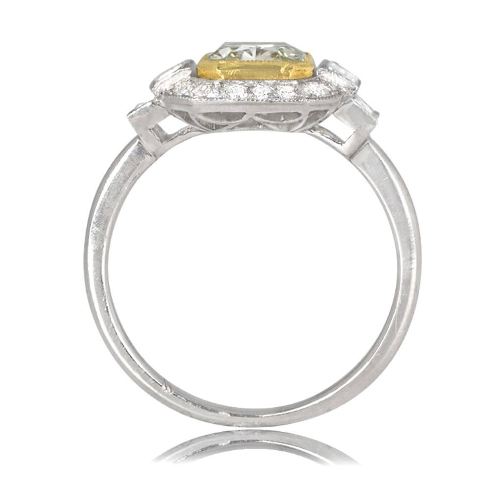 This engagement ring features a rare and certified 1.15-carat Fancy Yellowish Green diamond with VS1 clarity, bezel-set in 18k yellow gold. Surrounding the center stone are white round and baguette diamonds weighing approximately 0.50 carats. The