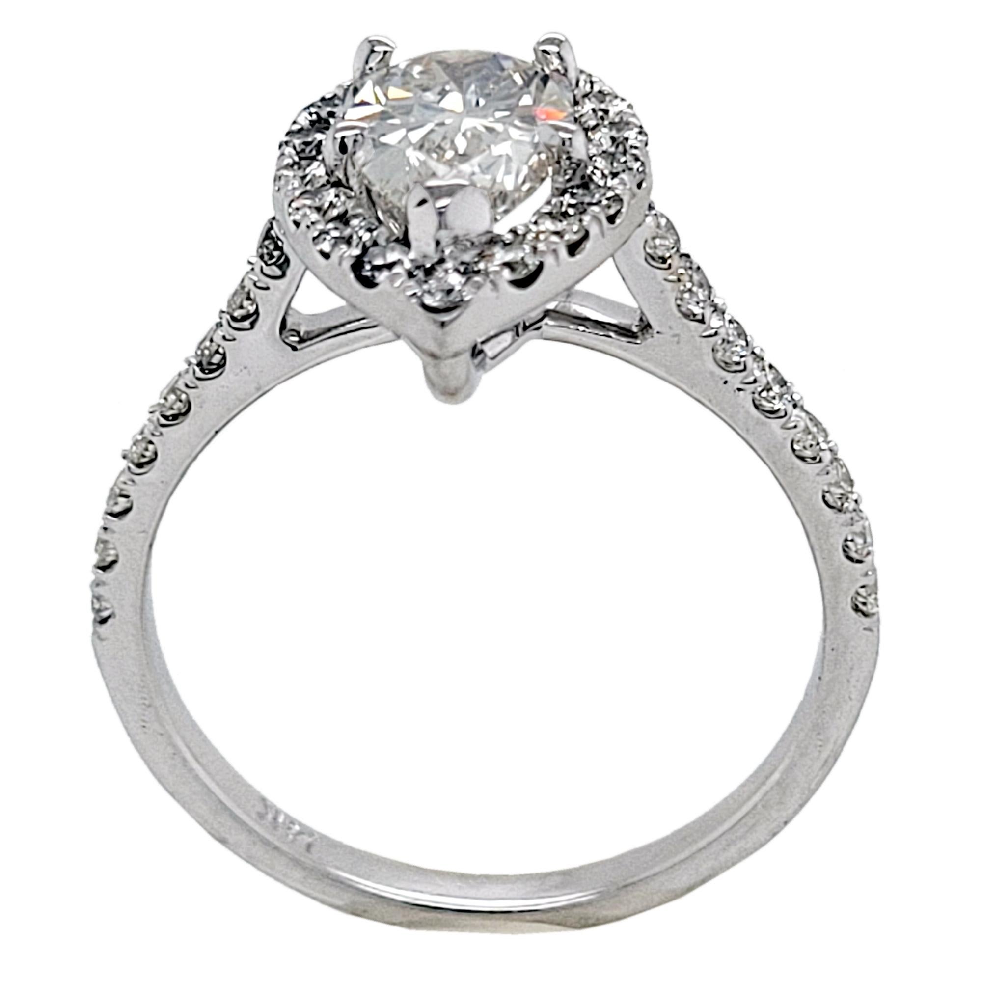 A 1.20 Ct Pear Shaped I/SI2 GIA certified center Diamond set in a beautiful 14K Gold pave set Engagement Ring with Halo.  Total weight of diamonds on the side is 0.60 Ct.

Diamond specs:
Center stone: 1.20 Ct GIA Certified I/Si2 Pear shape 
Center