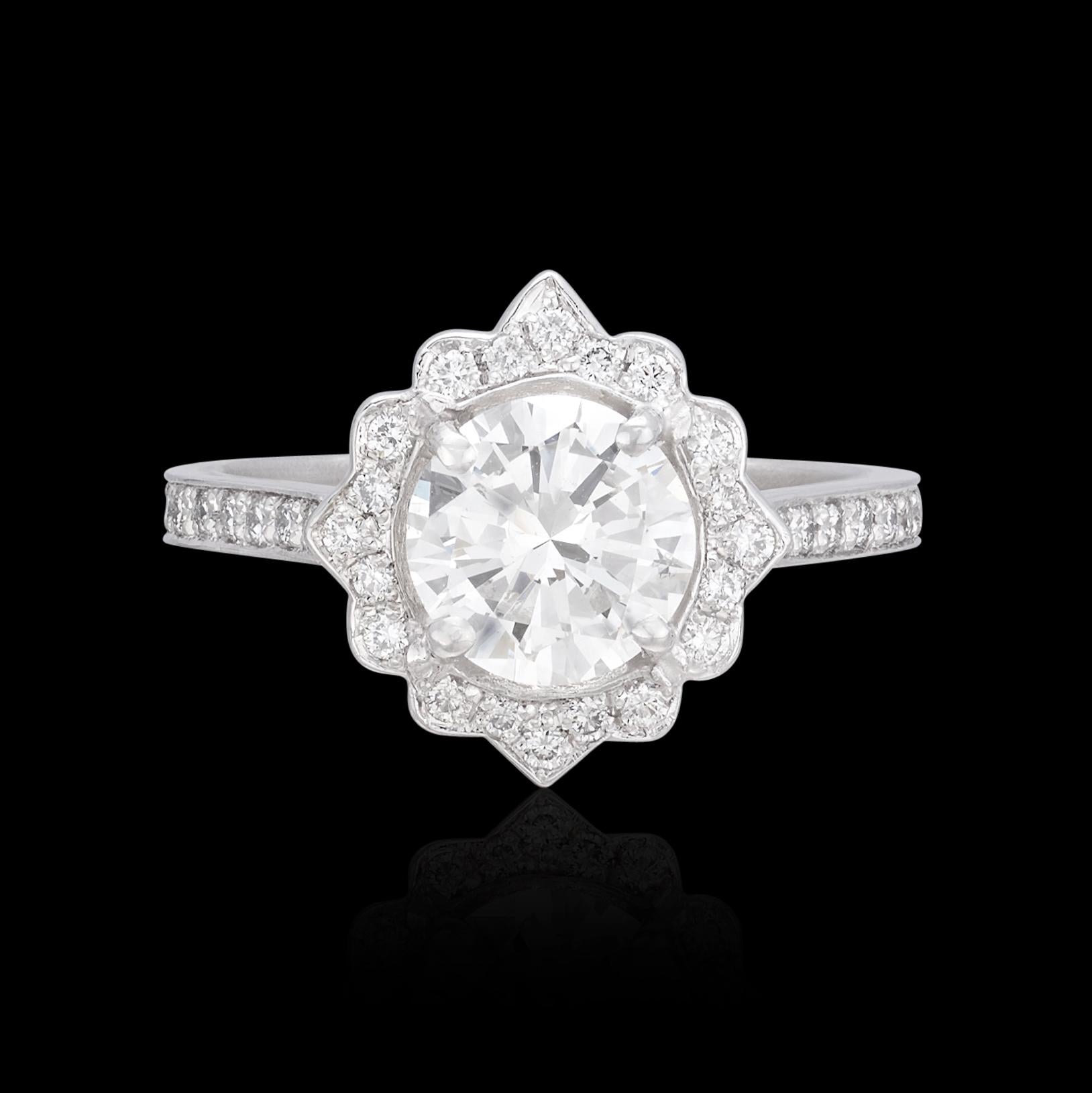 Romantic and eye-catching, the platinum ring features a gorgeous 1.22-carat round brilliant-cut diamond, GIA graded J/SI1, in a delicate floral design mounting set with 38 accent round brilliant-cut diamonds, giving the ring a total weight of