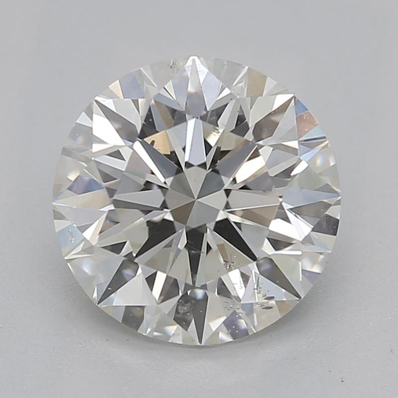 Handcrafted in New York, this stunning diamond ring showcases a breathtaking round J SI2 1.22 center diamond, expertly secured in a classic prong setting that enhances its brilliance. Surrounding the captivating centerpiece is a channel of petite