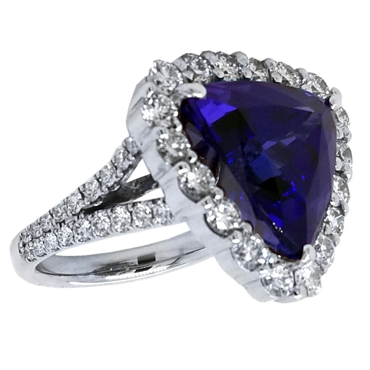 A beautiful color GIA Certified 12.40 Ct Trillion shaped tanzanite set in the center of an 18K split shank pave set diamond engagement ring with a halo to create great contrast. 

Details:
Center Stone: 12.40 carat Trillion tanzanite
Side Stone