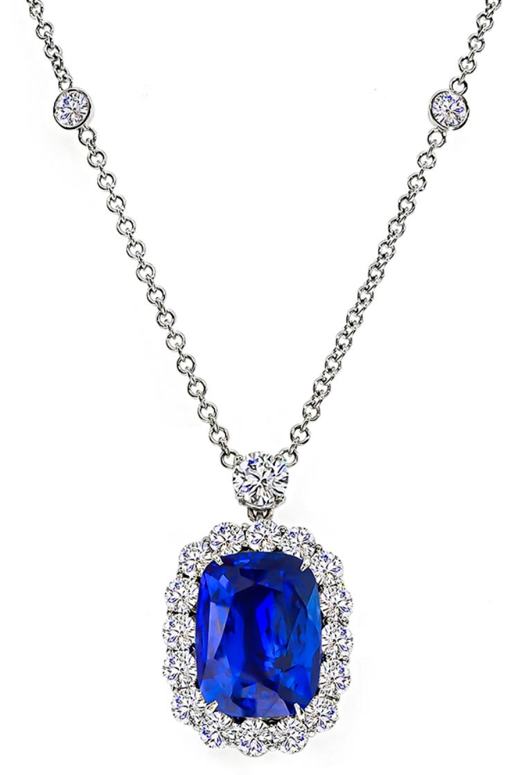 This gorgeous platinum pendant necklace is centered with a lovely GIA certified cushion cut Ceylon sapphire that weighs 12.43ct. The sapphire is accentuated by sparkling round cut diamonds that weigh approximately 3.80ct. graded F-G color with VS