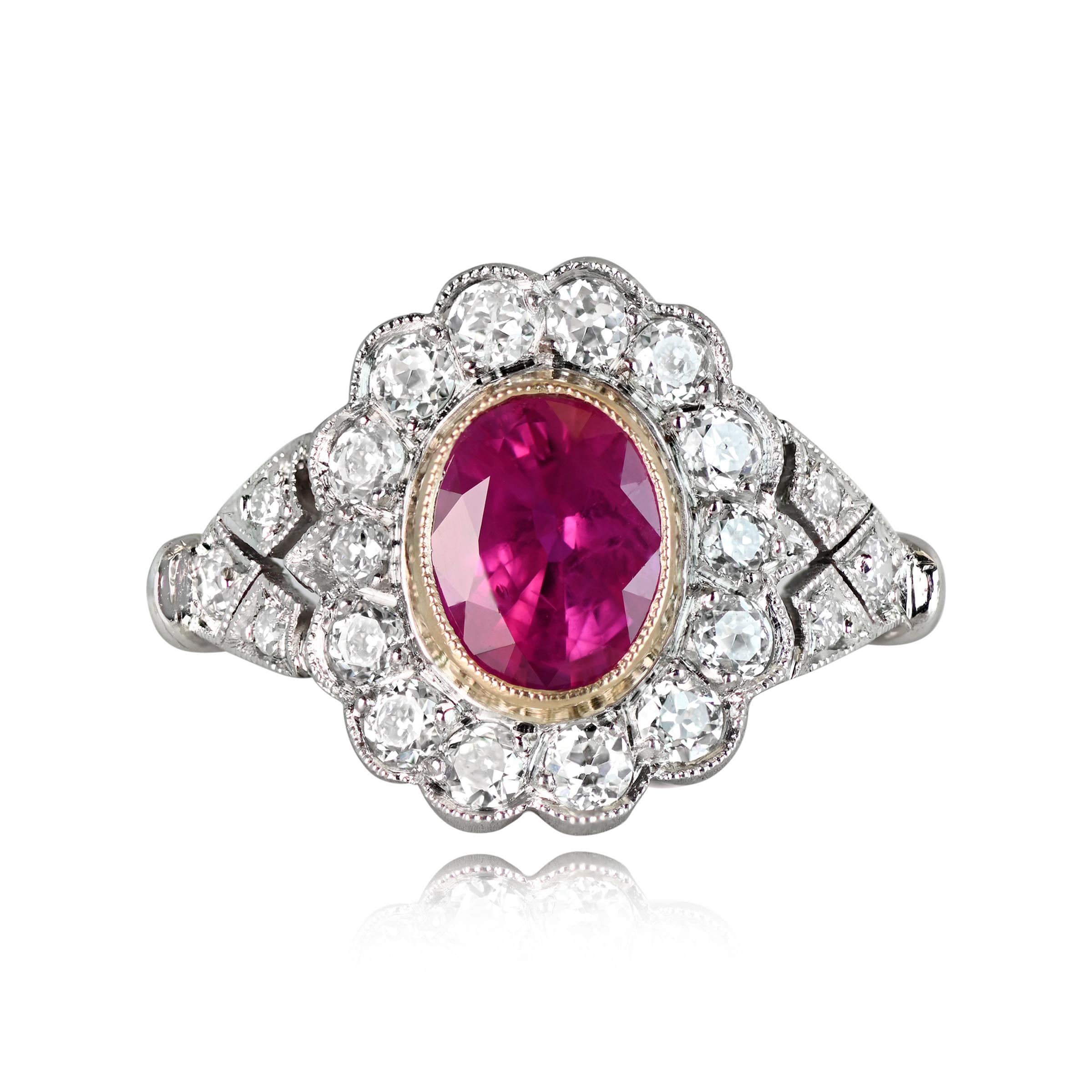 A captivating floral motif ring showcases a GIA-certified oval-cut 1.26 carat natural Burma ruby, encased in an elegant 18k yellow gold bezel. Surrounding the ruby is a mesmerizing floral halo of old European cut diamonds, artfully half-bezel set.