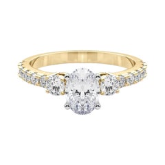 GIA 1,2ct Anello ovale a tre pietre con gambo di diamante in oro giallo 18 carati