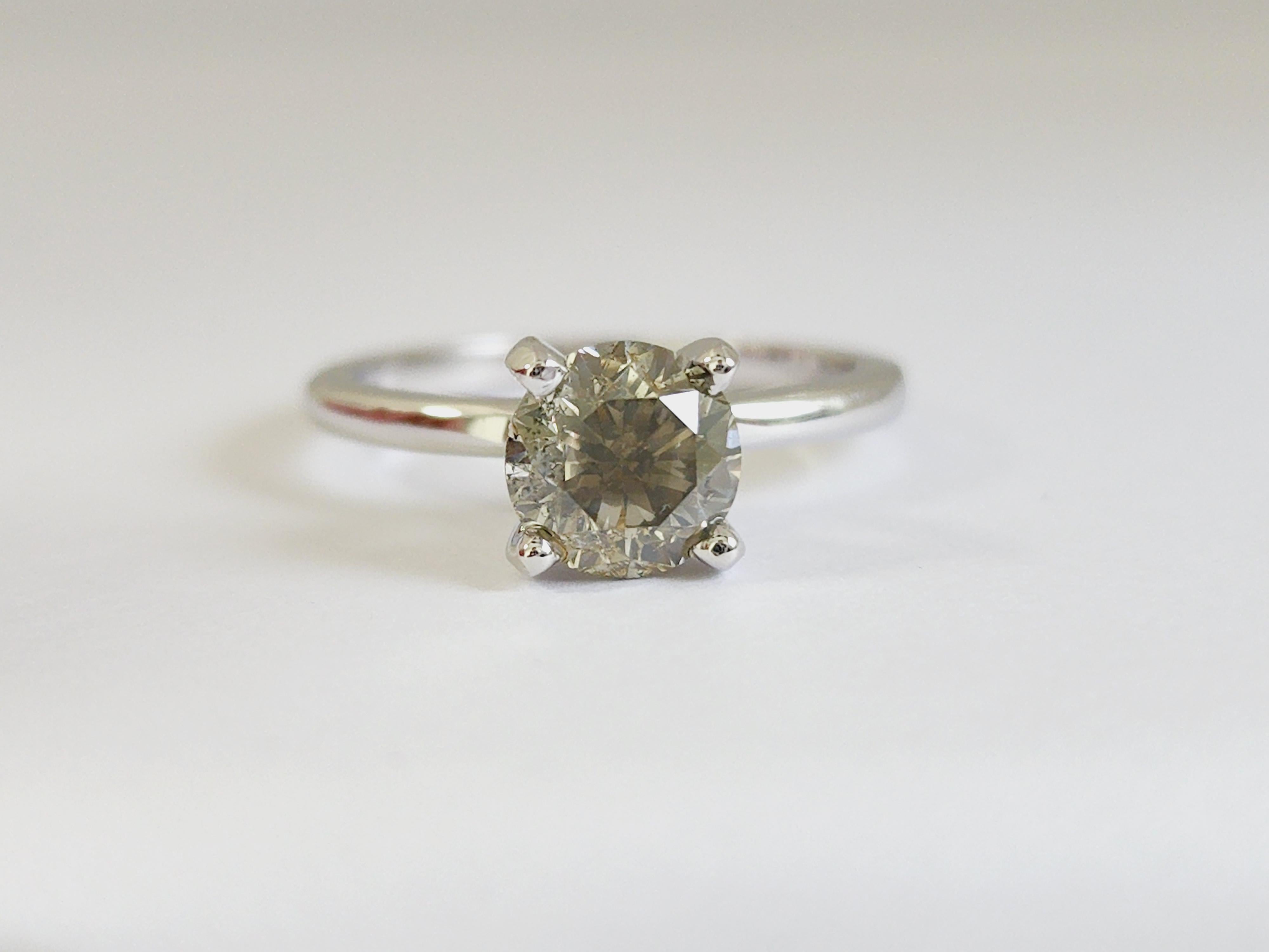 1.34 Carats round diamond set on a 4 prong white gold 14 Karat solitaire Ring. 
Natural Fancy Greenish Yellow-Brown
Size 6.5