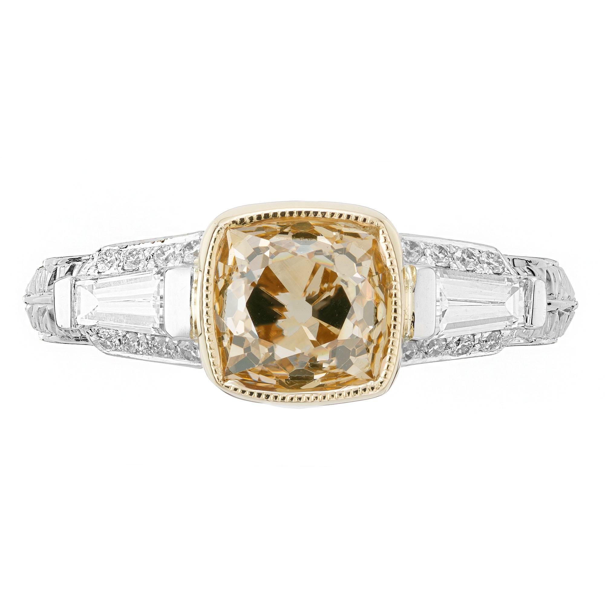 Brown and yellow diamond engagement ring. Antique cushion cut natural fancy brownish yellow bezel set center stone, with 2 tapered baguette side diamonds. 16 round accent diamonds. Handmade three-stone Platinum setting with an 18k yellow gold crown.