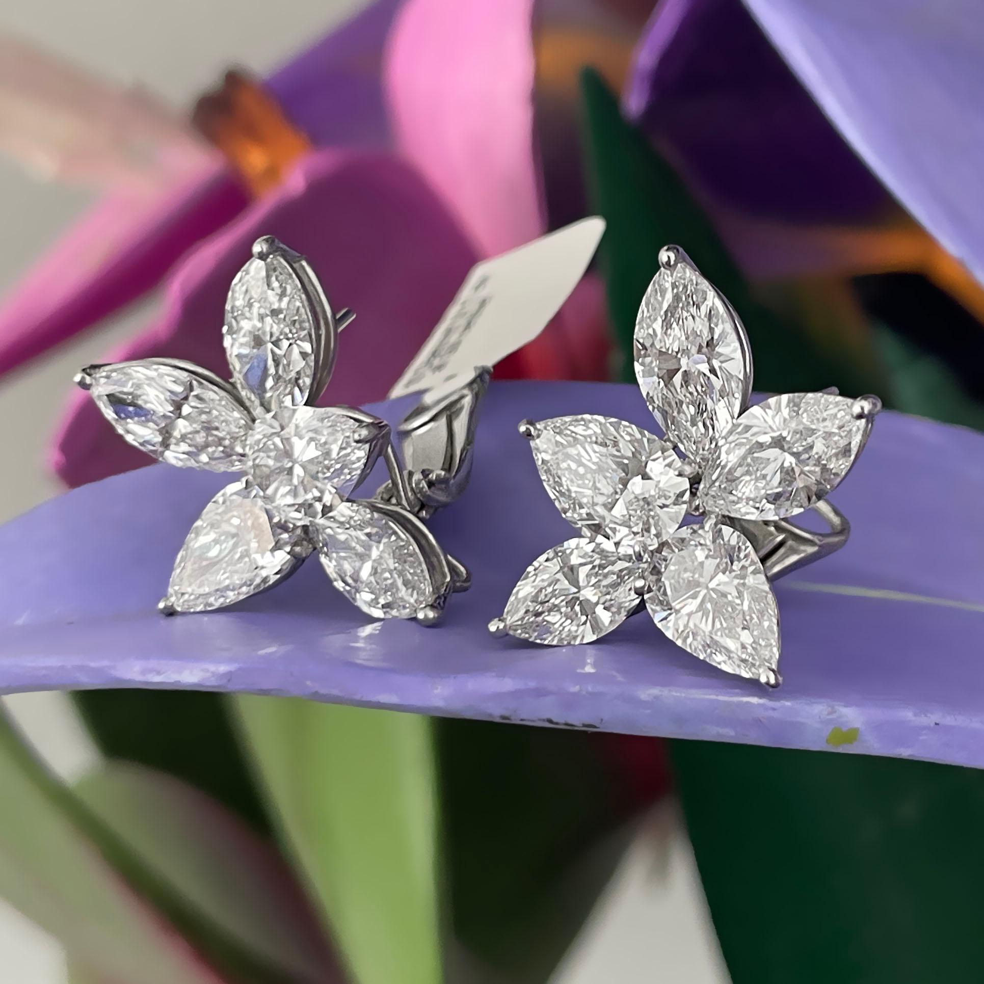 GIA certified platinum lever back diamond cluster earrings made to perfection. The brilliance of these certified, D/ E/ F color diamonds are stunning. The clusters are made with 4 pear and 6 marquise shape diamonds and weigh 14.17 carats total.
All