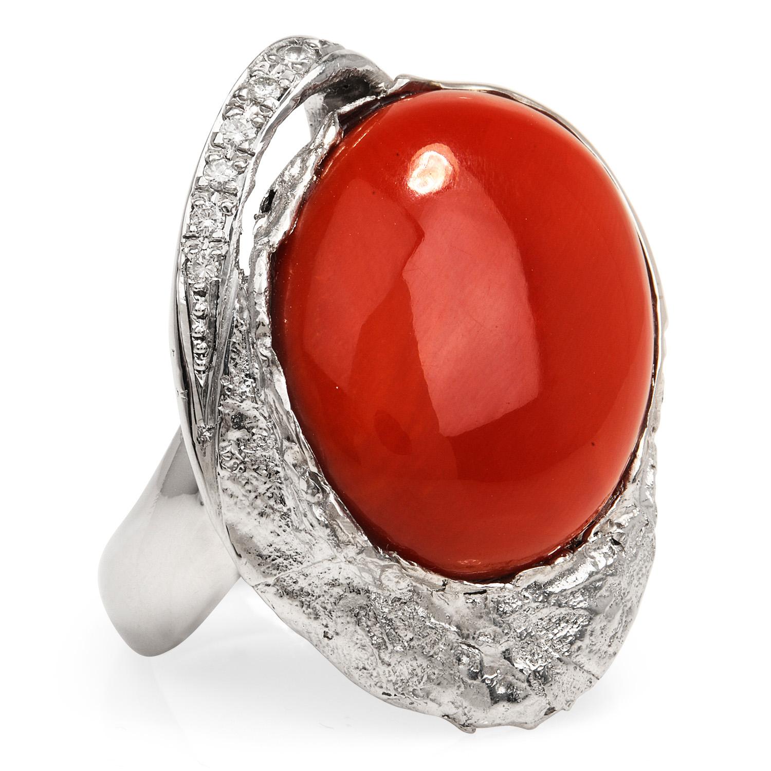 With a Bypass nugget design, this is an uncommon coral cocktail ring, 

Hand-Crafted in solid Platinum, the center is adorned by a GIA certified Natural Non-dyed Red Coral, oval cabochon shaped, bezel set weighing approximately 14.25 carats. 

As a