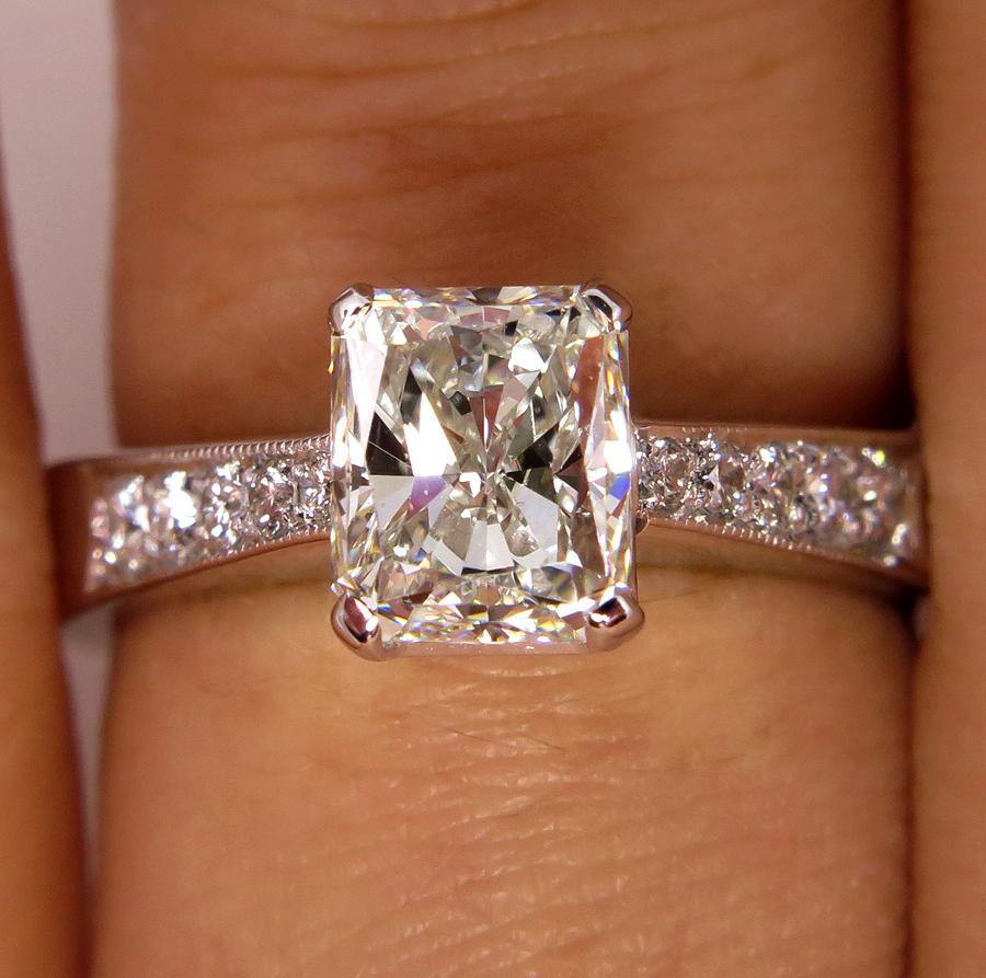 A gorgeous, bright-white and brilliantly designed Radiant cut Diamond Solitaire ring with a 1.20CT Center Diamond! From our Estate Collection. The total diamond weight is 1.42ct

LARGE BRILLIANT RADIANT cut Center Diamond!

The diamond is J color ,