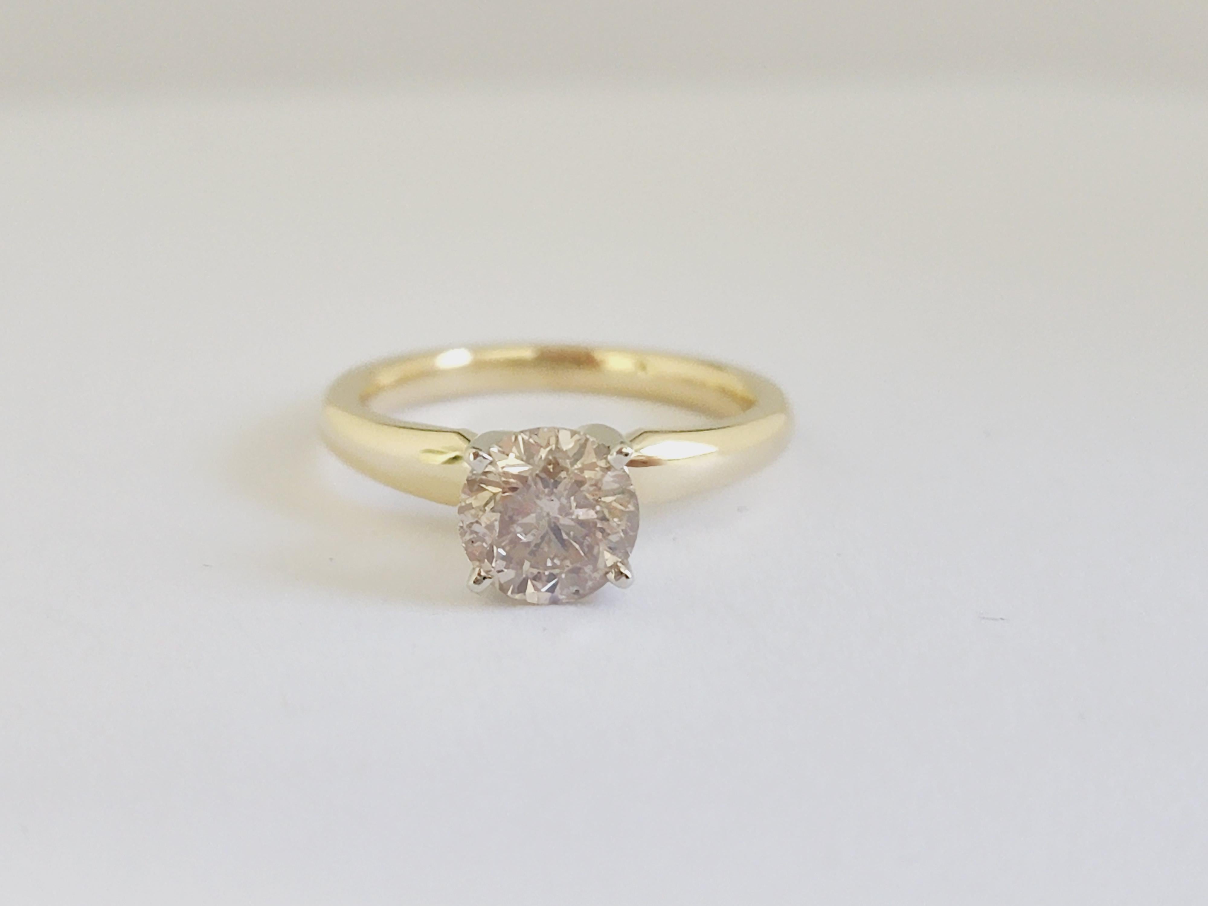 GIA Natural light brown round diamond weighing 1.47 carats. Set on 4-prong 14K solitaire yellow gold ring

Ring size: 6.5