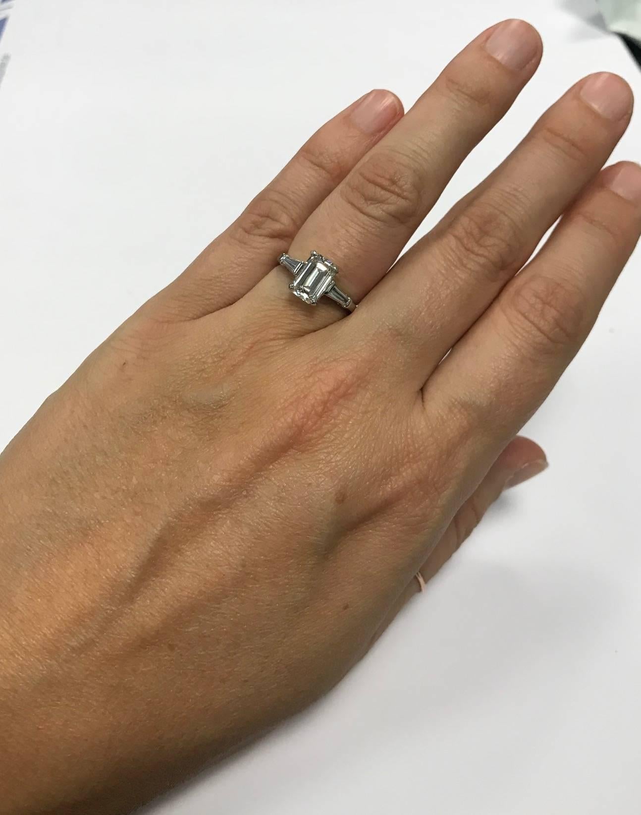 Beautiful emerald cut diamond mounted in a platinum ring with two tapered baguettes on the sides weighing approximately .25 carat The center diamond has a certificate from the Gemological Institute of America stating that it is 