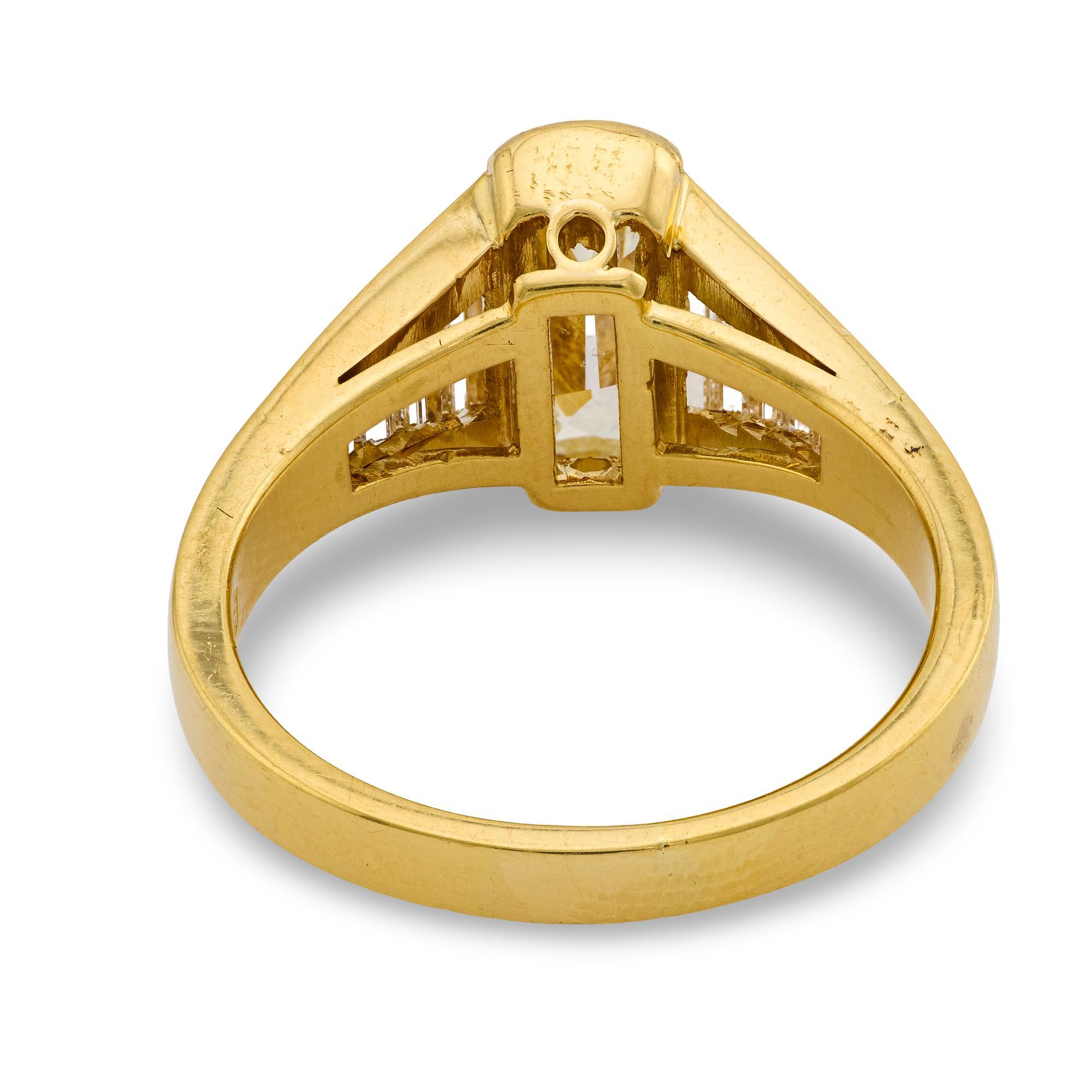 This vintage 1980’s ring highlights a 1.51 carat elongated cushion cut diamond, certified by GIA, accented by a striking arrangement of baguette cut diamonds in radiant 18k yellow gold.