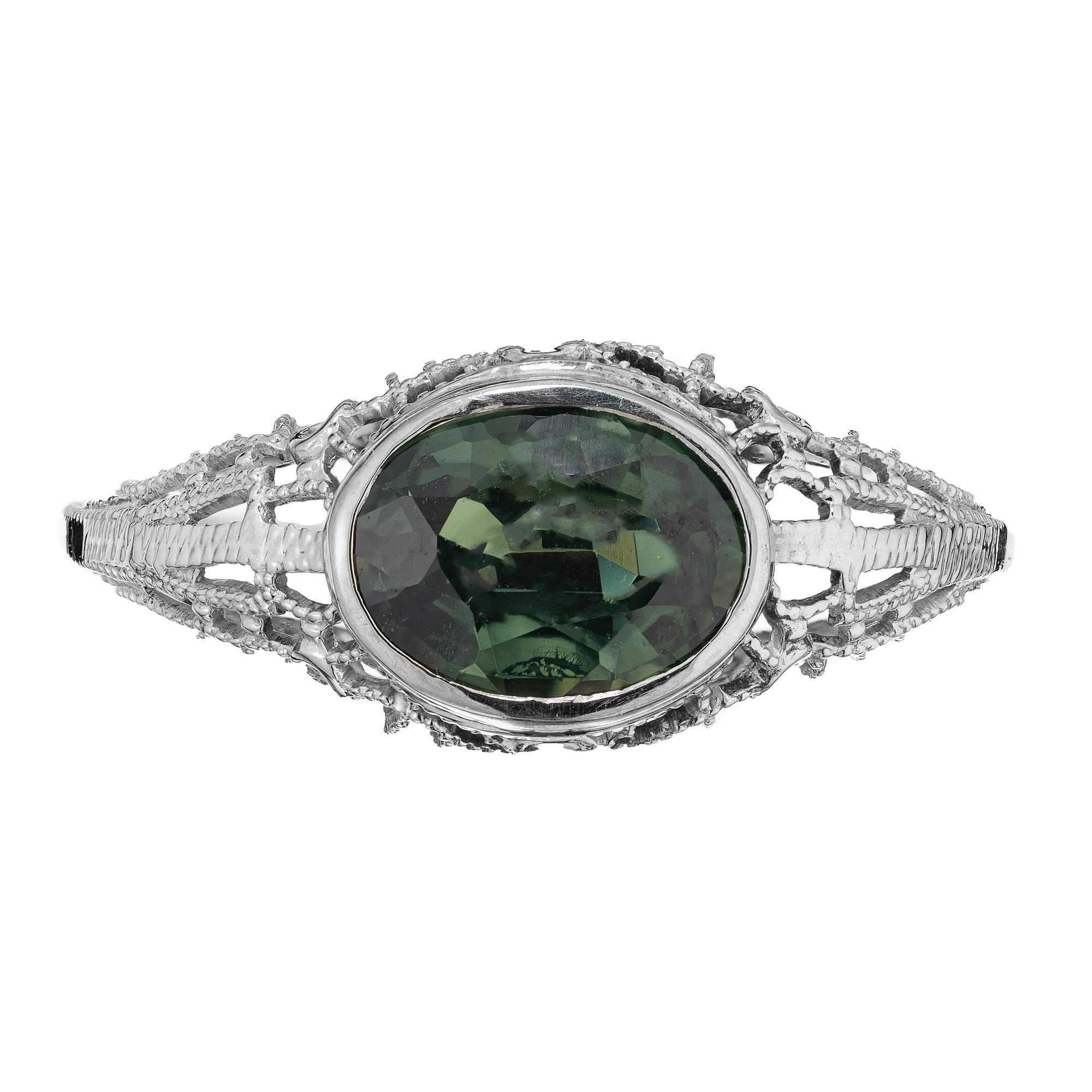 1930's Art Deco rich green sapphire engagement ring. This 1.51ct oval green sapphire is mounted sideways in a filigree 14k white gold setting. The GIA has certified the sapphire as natural, no heat. The striking green hues of the sapphire are