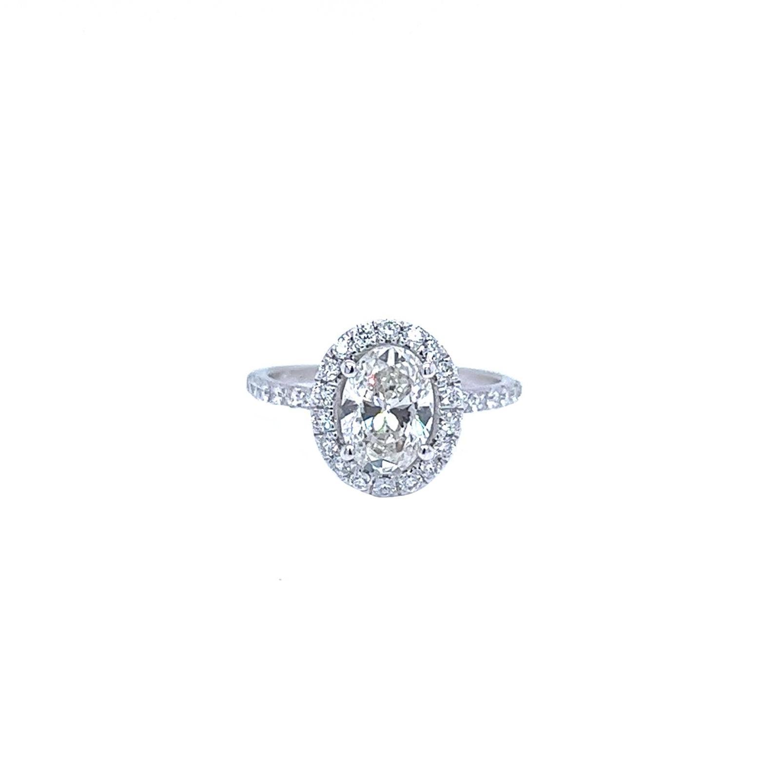 This lovely Oval Cut Natural Diamond Pave Ring Features an H color and VS2 clarity and it is surrounded by round diamonds, with a size of 6 (Sizeable), This Oval Diamond Ring sparkler would be enough to brighten anyone’s day. Crafted in 18K White