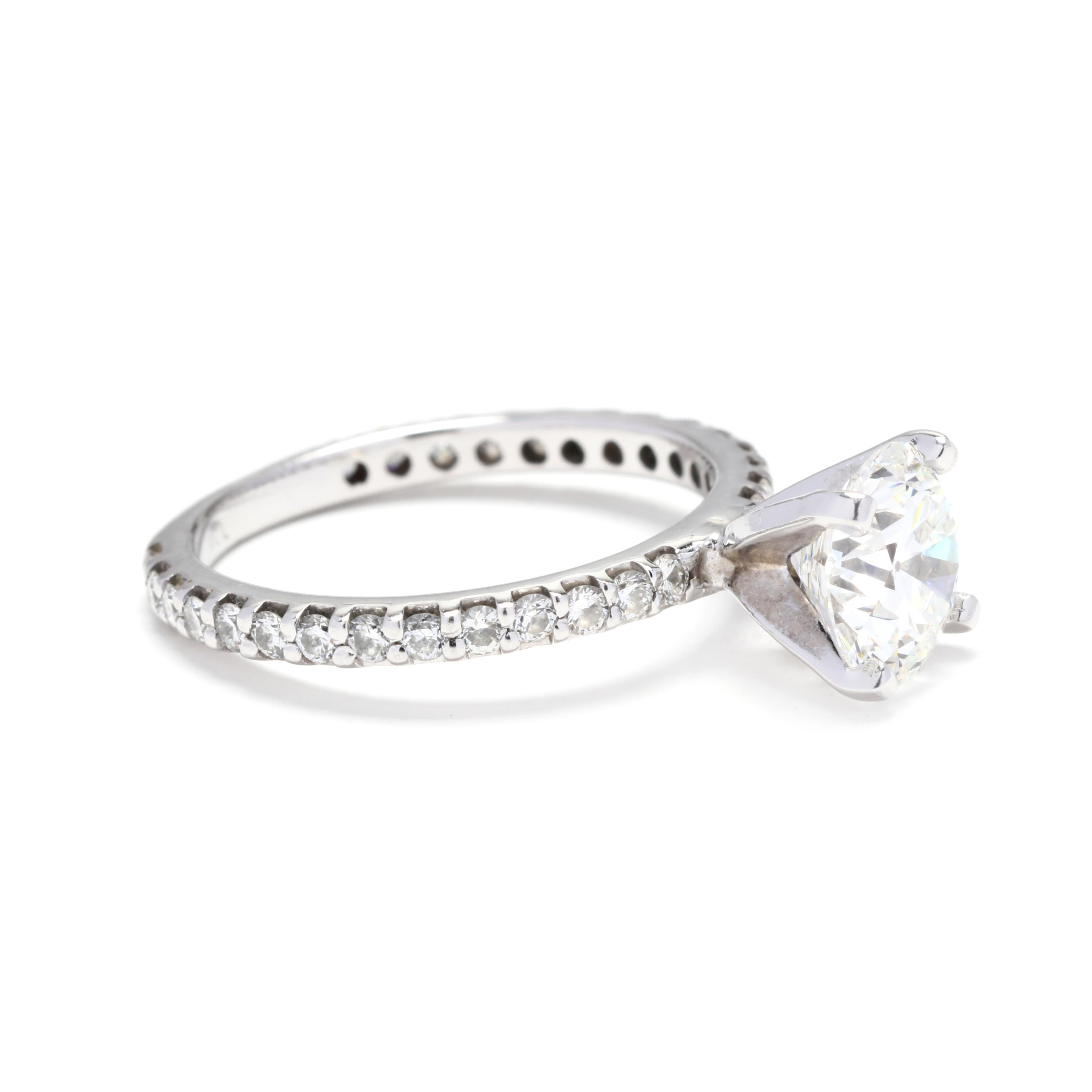 14k white gold GIA 1.53ct round diamond engagement ring. An impressive solitaire engagement ring with a 1.53 carat center, round brilliant cut diamond. The diamonds is set in four prongs. The setting has round diamonds set three-quarters of the way
