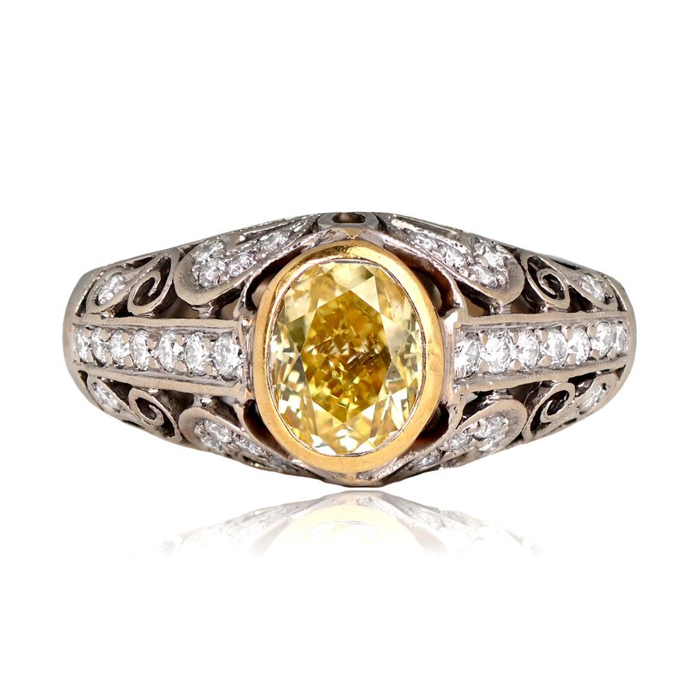 An exquisite fancy-colored diamond ring featuring a 1.54-carat GIA-certified oval-cut diamond in Fancy Intense Yellow with SI1 clarity. The center stone is elegantly bezel-set in yellow gold, with the mounting crafted in platinum. The ring showcases