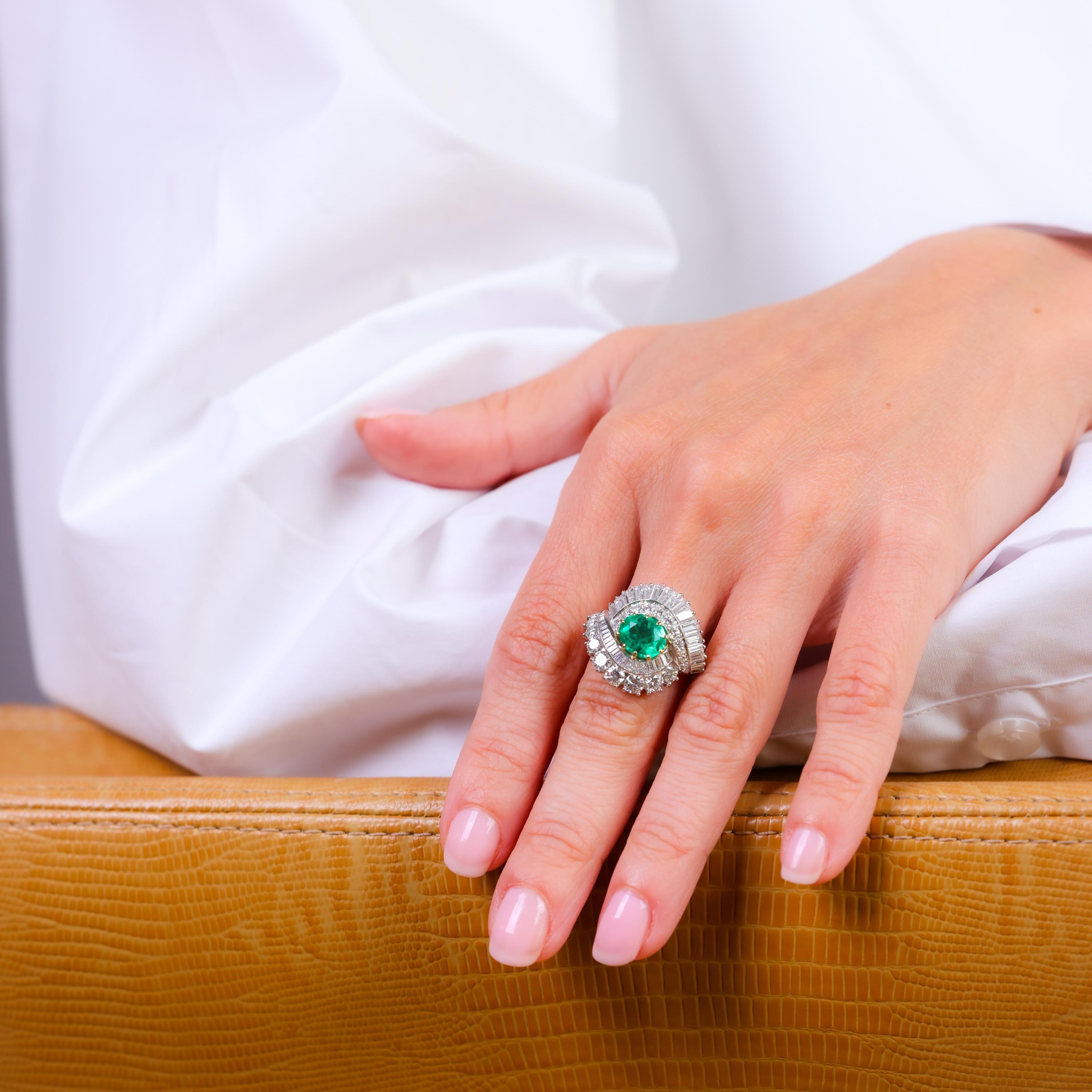 This stunning Mid Century ring showcases a GIA-certified Colombian emerald and 4 carats of dazzling diamonds in an exquisite 18k white gold setting.