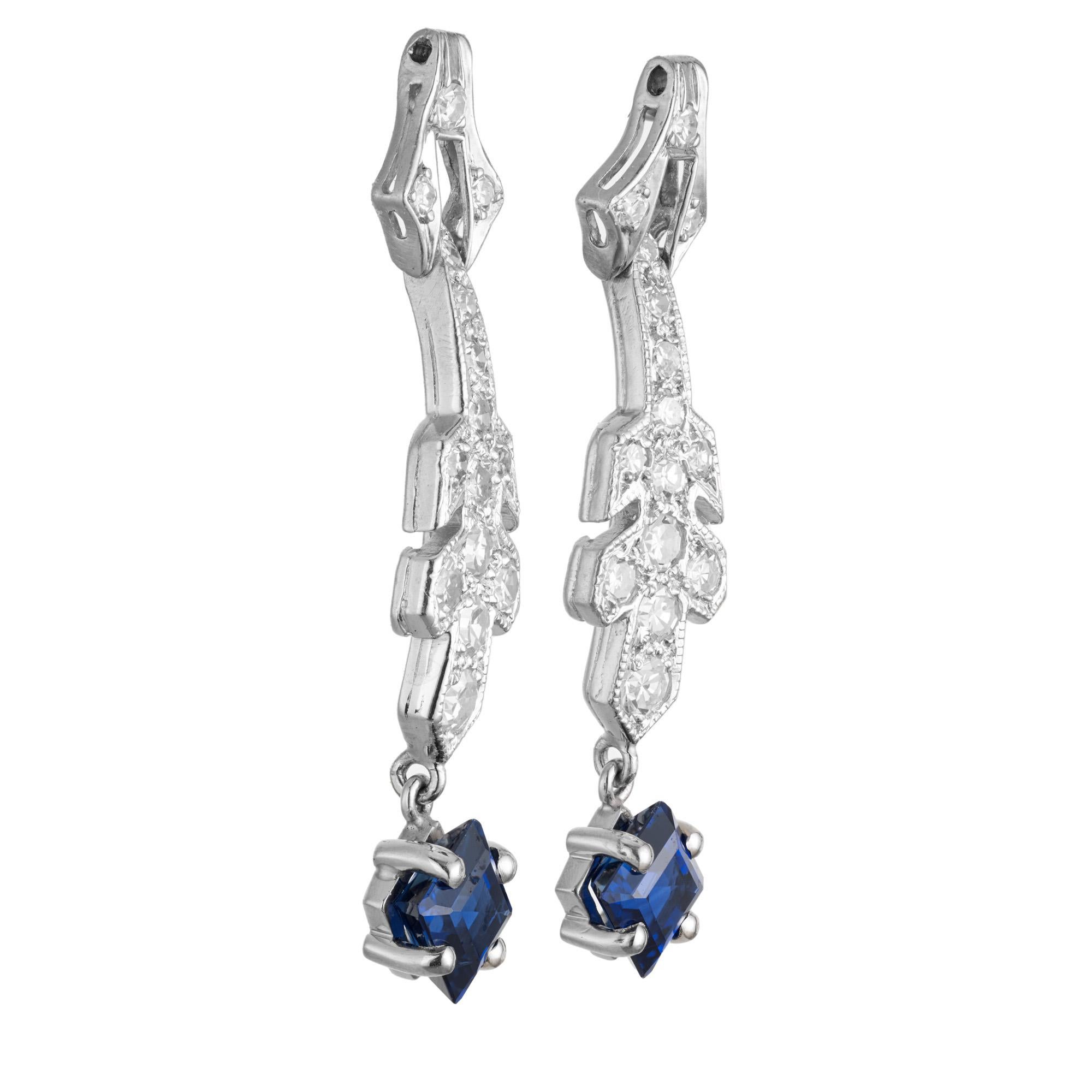 Art Deco sapphire and diamond dangle drop earrings. These 1920's dangle earrings are made up of 2 octagonal shape sapphires which sit at the base of two platinum settings that are adorned with 30 single cut diamonds. Both of the stones have