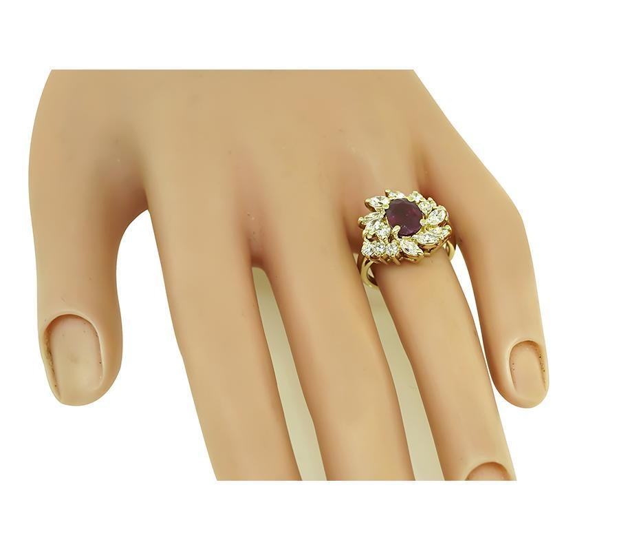 This is a fabulous 14k yellow gold ring. The ring is centered with a lovely oval cut GIA certified Burma ruby that weighs 1.67ct. The ruby is accentuated by sparkling marquise and round cut diamonds that weigh approximately 1.00ct. The color of