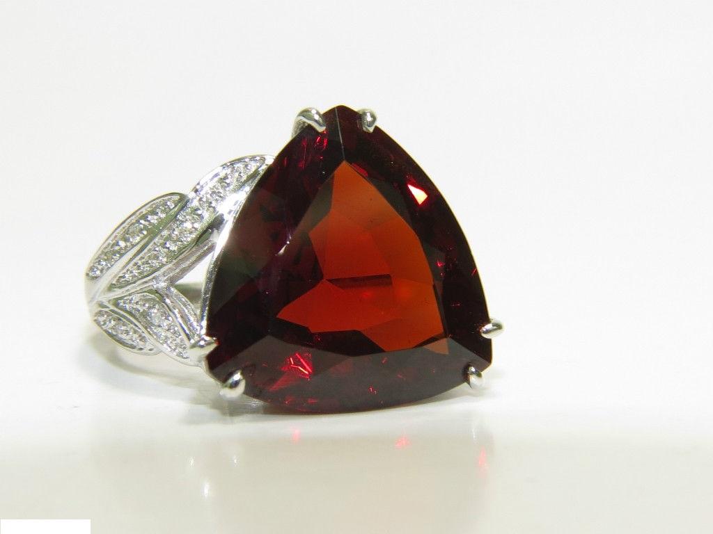 GIA

17.94ct. Natural  Spessartite

Excellent tone

The stone is flashing threads of Red-orange sparkles throughout

VVS - clean clarity

Brilliant and vibrant color

please see certificate for details.



.15ct. side round diamonds

H color, Vs-2