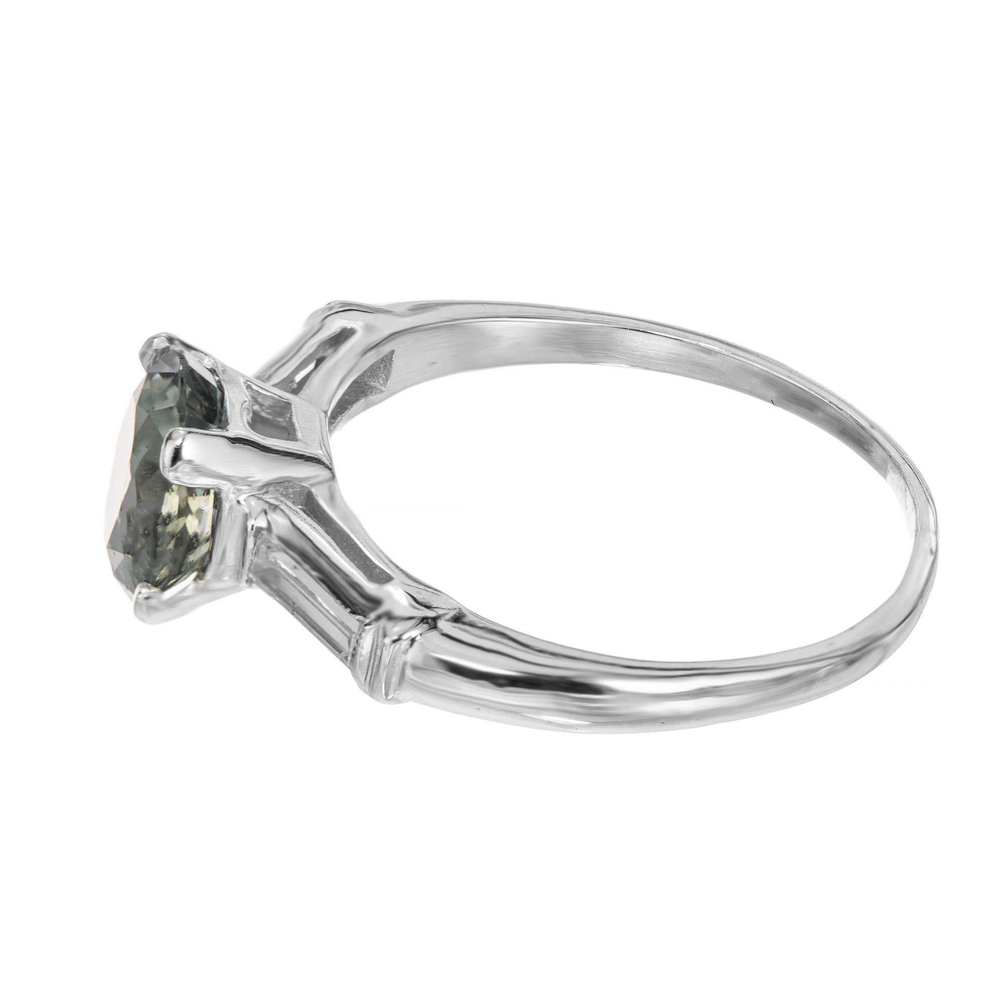 platinum ring with green stone