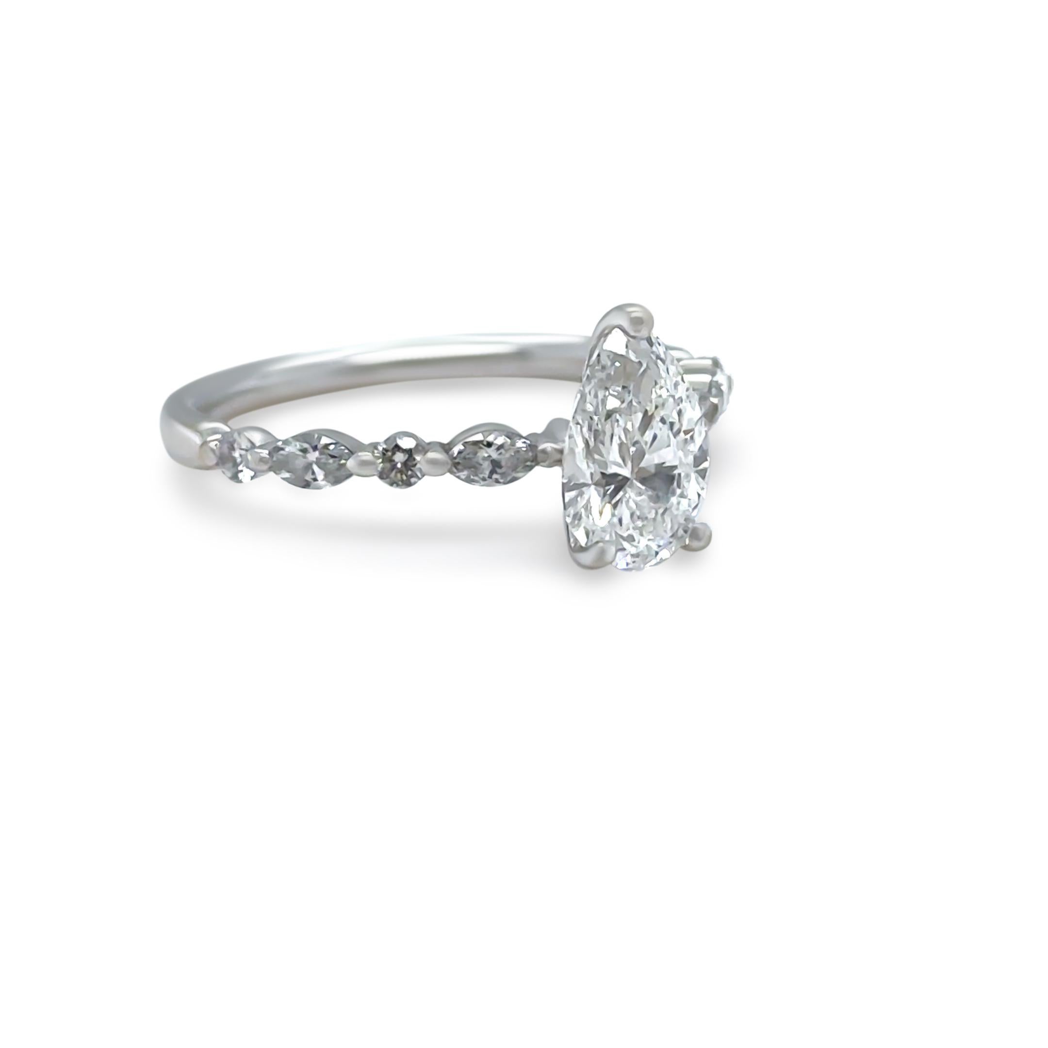 This stunning GIA diamond engagement ring is crafted in 18ct white gold, featuring a breathtaking 1.00ct pear-shaped diamond at its centre. The diamond is graded F colour and SI2 clarity, with GIA Report (#7363095443),

The centre diamond is