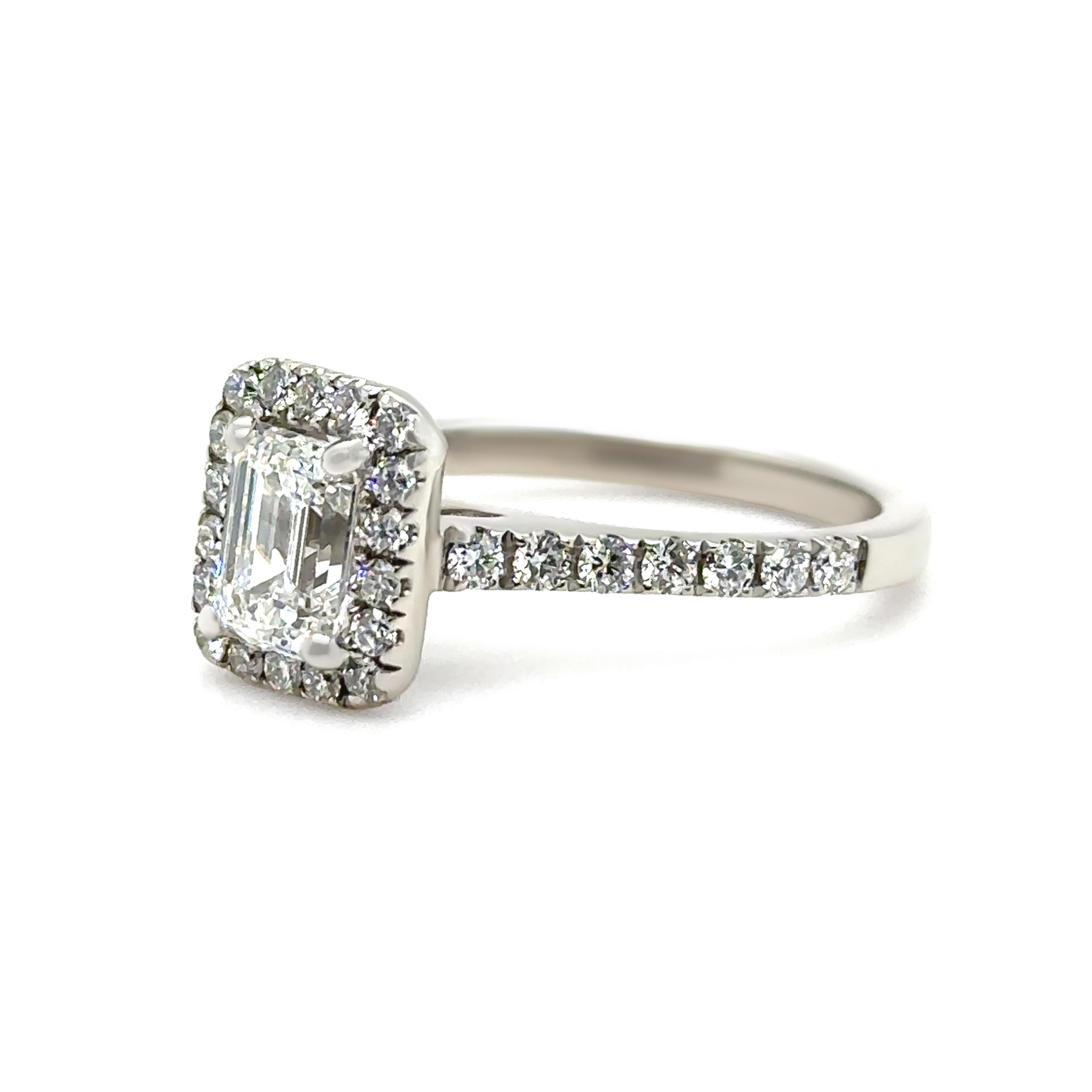 A beautifully handcrafted 18ct white gold engagement ring featuring a narrow, low half-round parallel shank with a straight underrail and polished finish. The centre is set with a GIA 1.05ct emerald cut diamond, graded F colour and VS2 clarity,