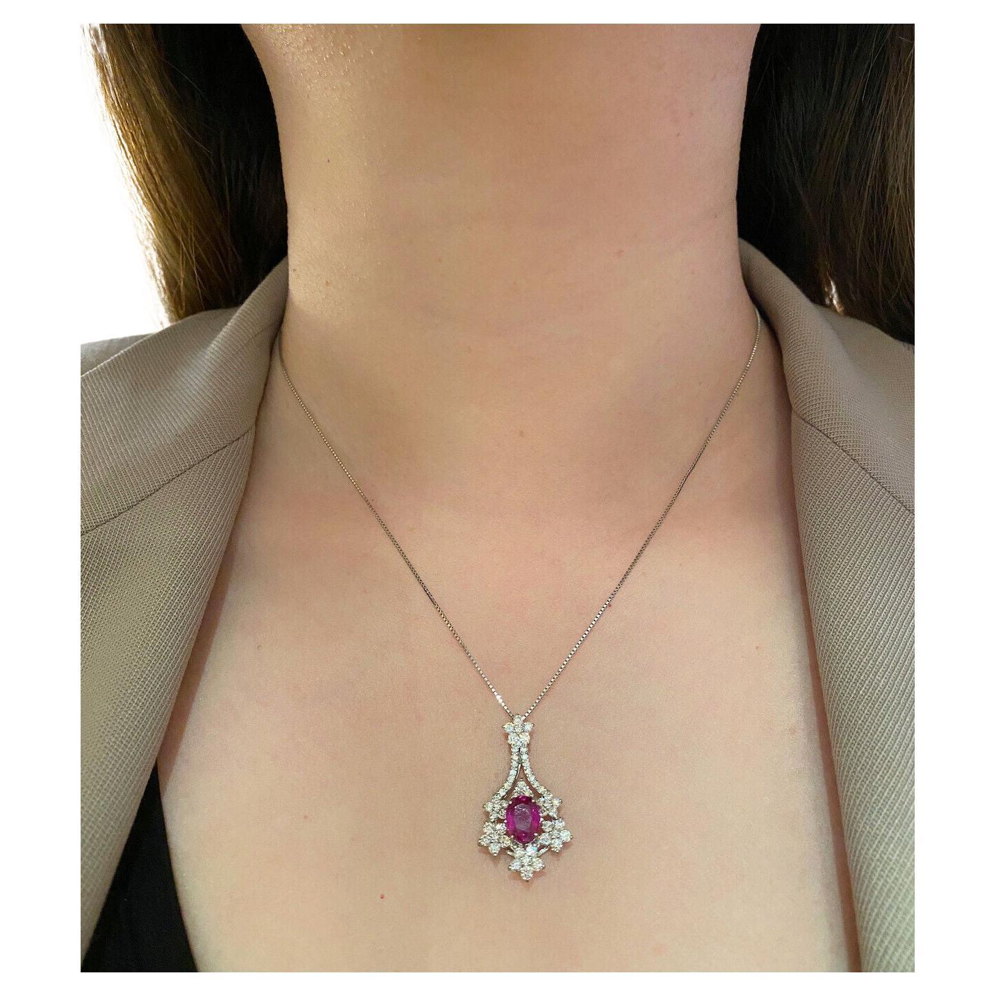 GIA Unheated Oval Ruby Pendant with Diamonds in Platinum

Ruby and Diamond Pendant Necklace features a large Oval shaped Red Ruby surrounded by Natural Round Brilliant Diamonds in fancy floral motif set in Platinum.

The Ruby originates from