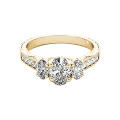 GIA Bague à trois pierres ovales de 1ct en or jaune 18 carats gravée en canal