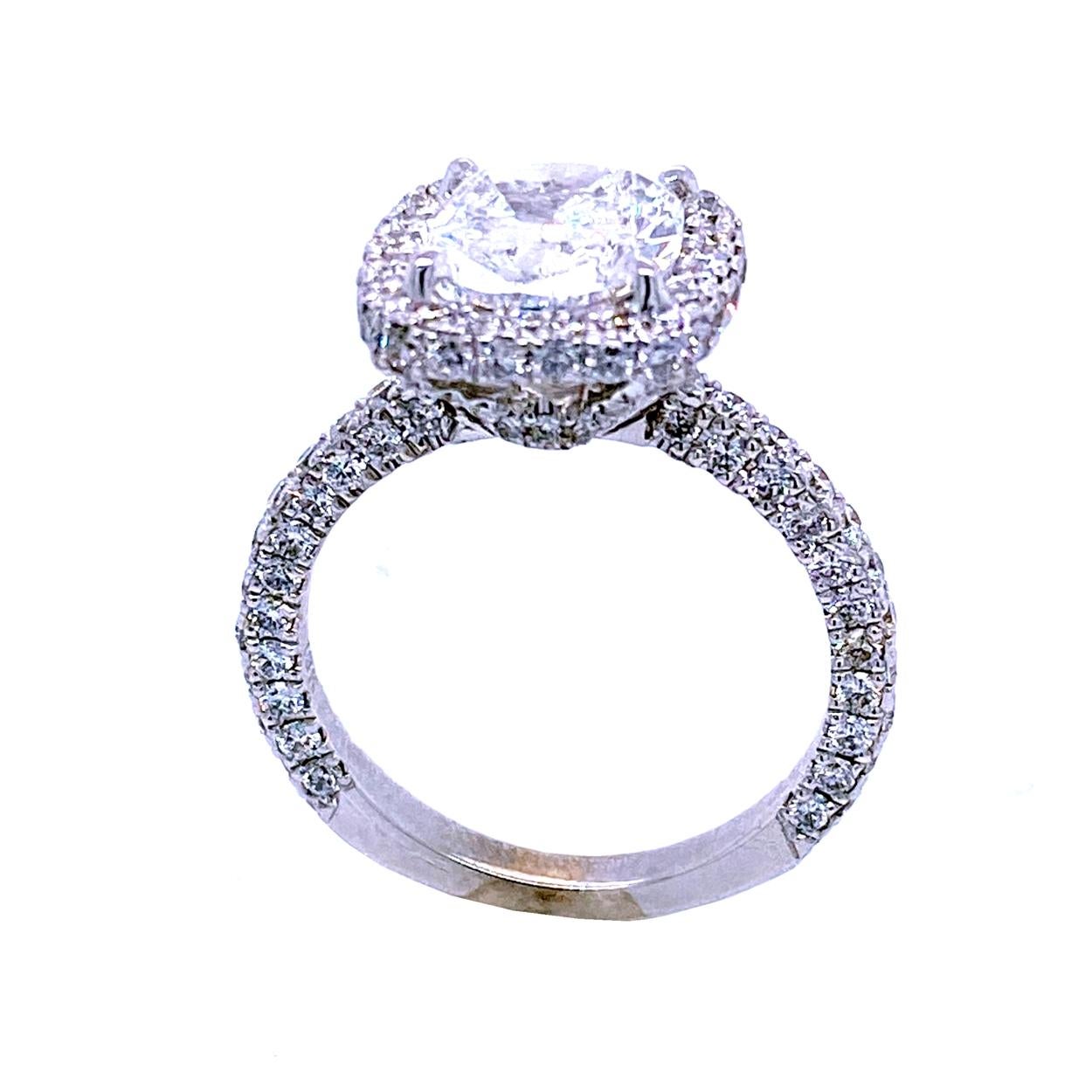 A very shiny 2.01 Ct Cushion D/SI1 GIA certified center Diamond set in a fine 18k gold Pave set Engagement Ring with a halo. You can see diamonds from all angles. Total diamond weight of 1.40 Ct. on the side. 

Diamond specs:
Center stone: 2.01 Ct