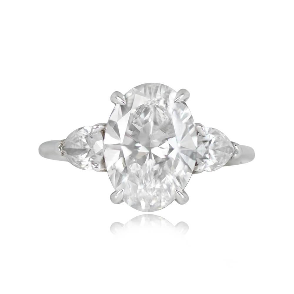 This elegant engagement ring features a GIA-certified 2.02-carat oval-cut diamond with exceptional D color and SI1 clarity, held in prongs. The shoulders of the ring are adorned with pear-shaped diamonds, collectively weighing 0.30 carats. Crafted