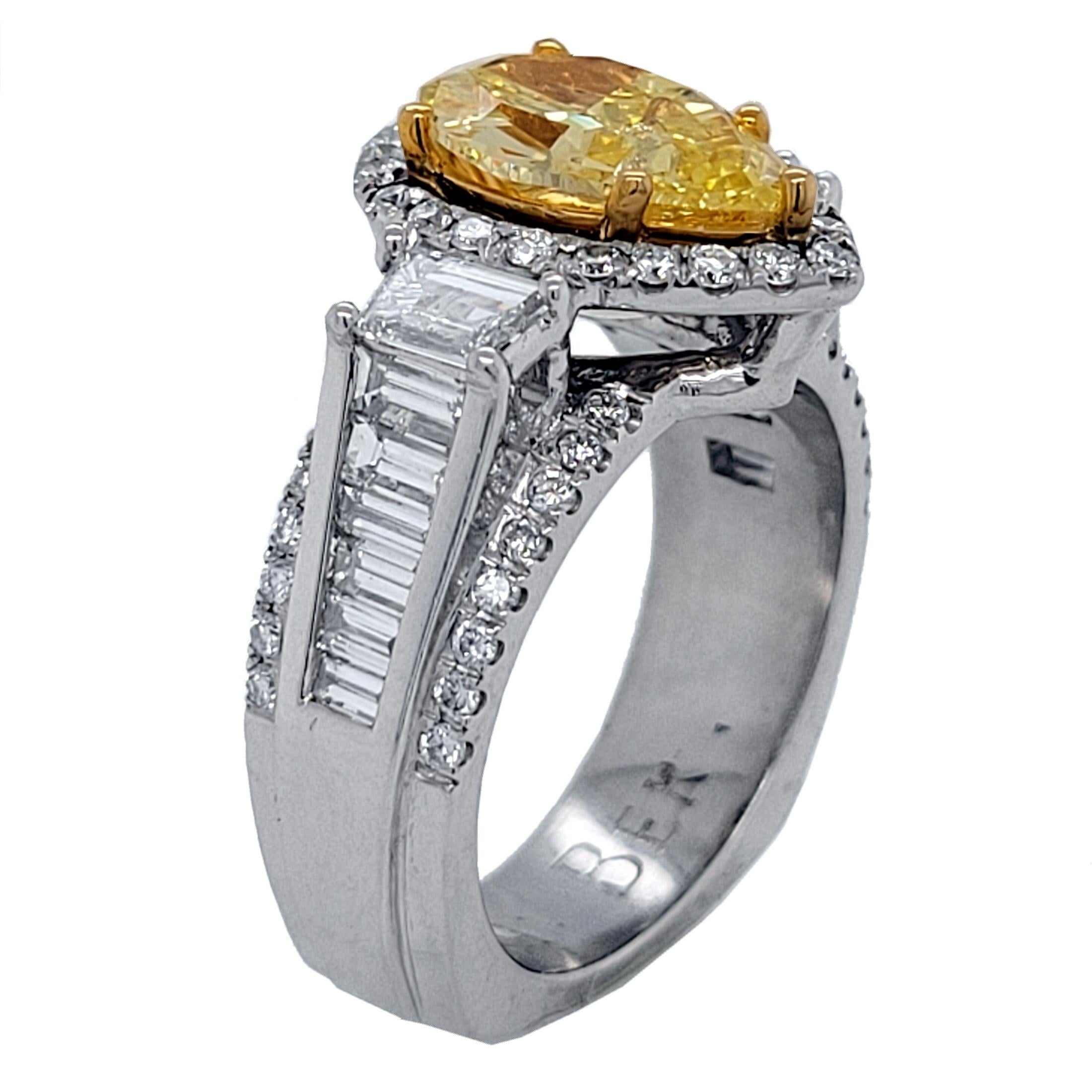 A beautiful Pear Shaped Natural Fancy Intense Yellow GIA certified center Diamond set in a gorgeous platinum pave set Engagement Ring with 2 Trapezoid diamonds on the side along with a series of Channel Set Baguette diamonds on the shoulder with