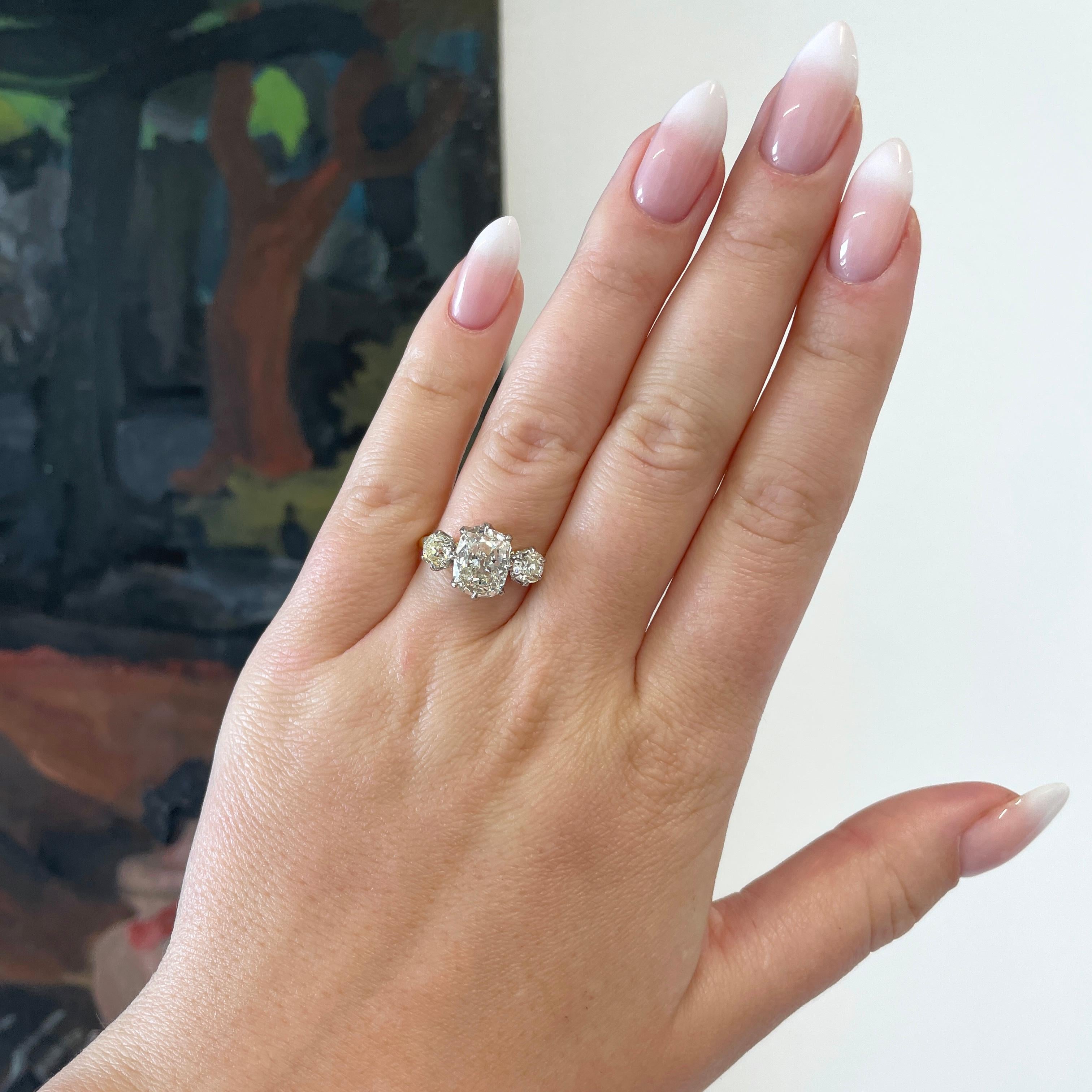 You'll love this exquisite 3-stone diamond ring. It's hard to take your eyes of this glorious Antique Cushion 18k Gold Three Stone Engagement Ring; and why would you want to.

The center stone is GIA certified 2.08 cushion cut diamond, K color, VS1