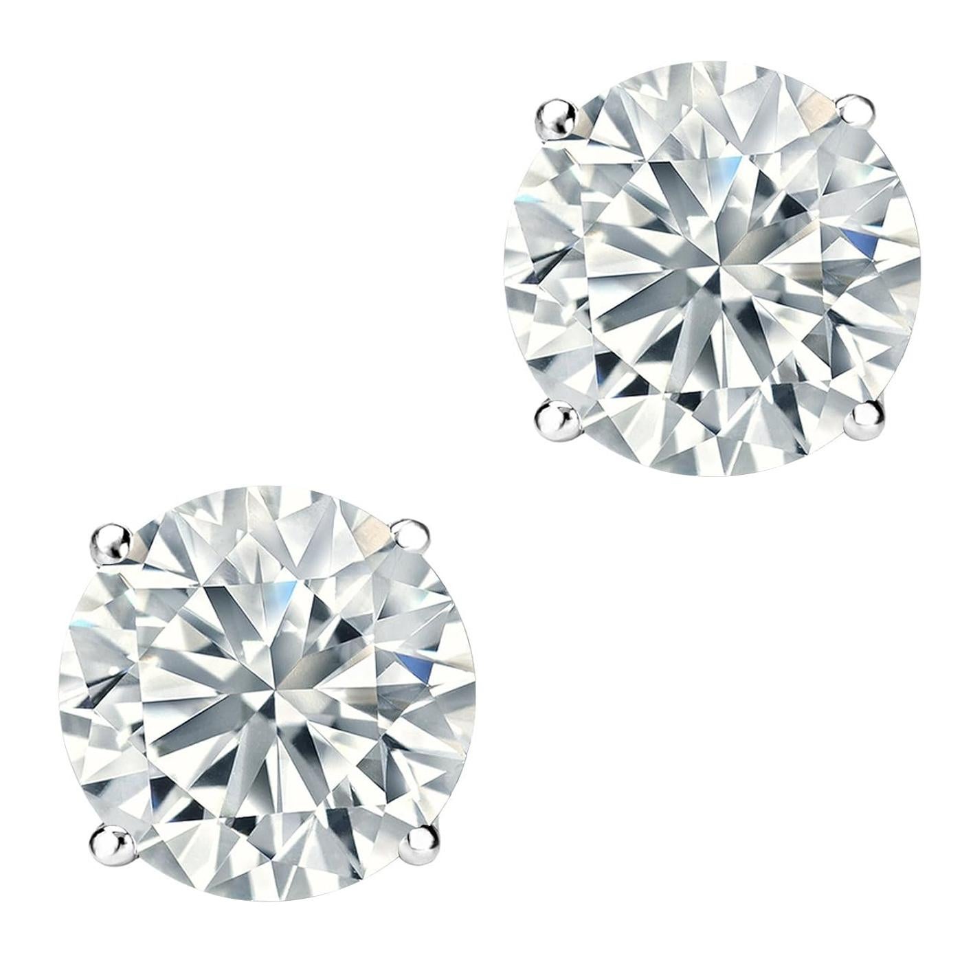 Captivate her with the stunning and dazzling look of these 4 prong basket-setting natural diamond earrings. Beautifully crafted in Platinum, these gorgeous diamond earrings feature 1.05ct / 1.04ct round cut diamonds on each Earring, with I/H color