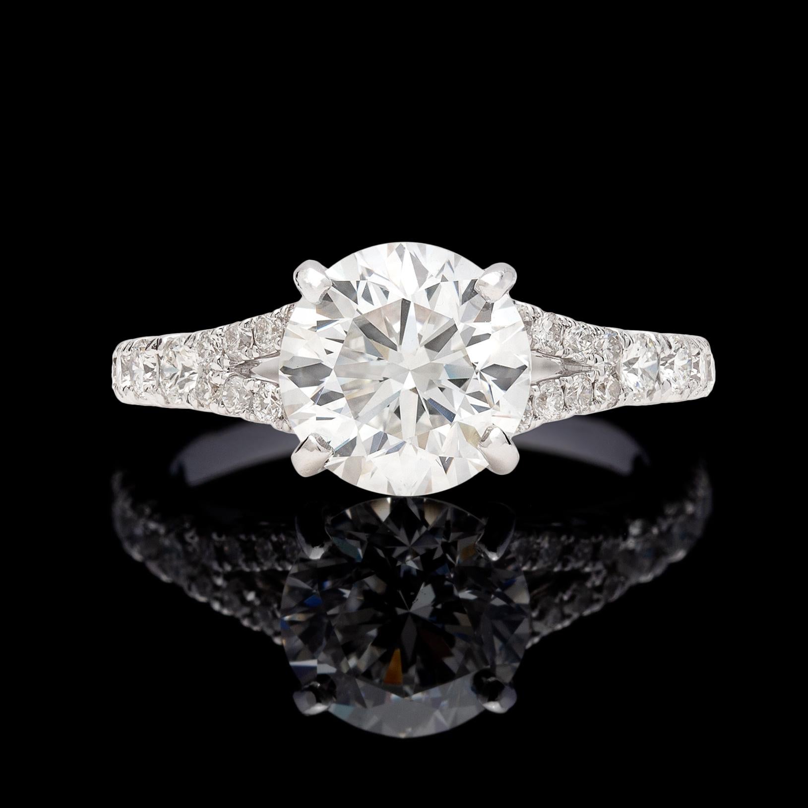 Gorgeous 18k white gold engagement ring featuring a sparkling 2.11-carats round brilliant-cut diamond, GIA F/SI1, with a split shank mounting set with 24 round brilliant-cut diamonds. Total weight for the ring is an estimated 2.51 carats. The ring