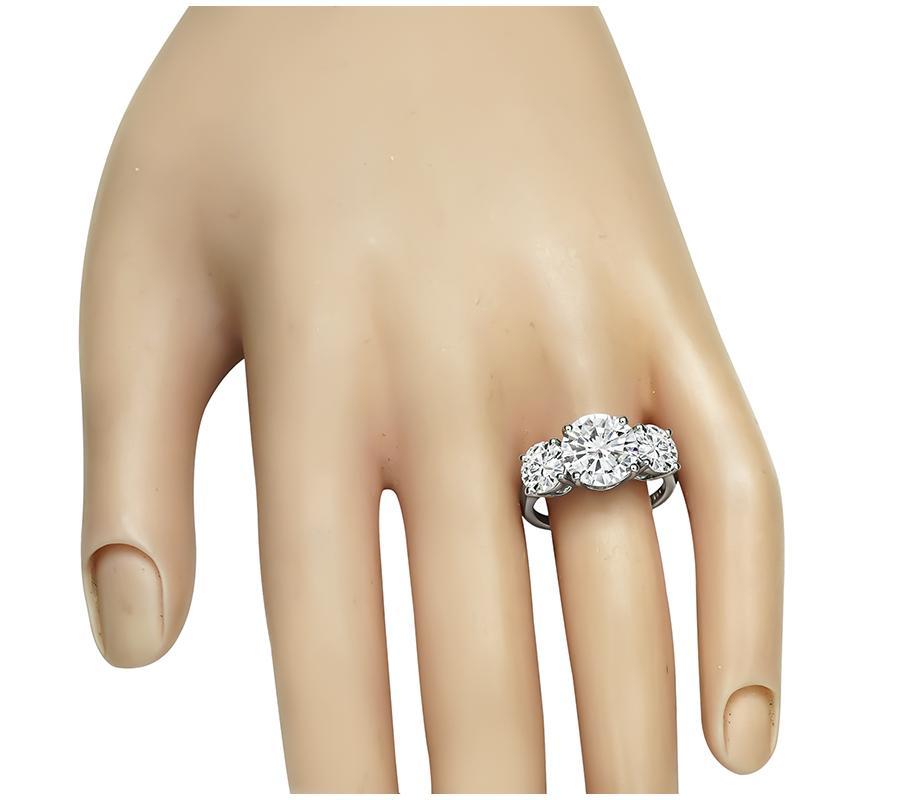 This is a stunning platinum engagement ring. The ring is centered with sparkling GIA certified round cut diamond that weighs 2.11ct. The color of the diamond is F with VVS2 clarity. The center diamond is accentuated by two dazzling GIA certified