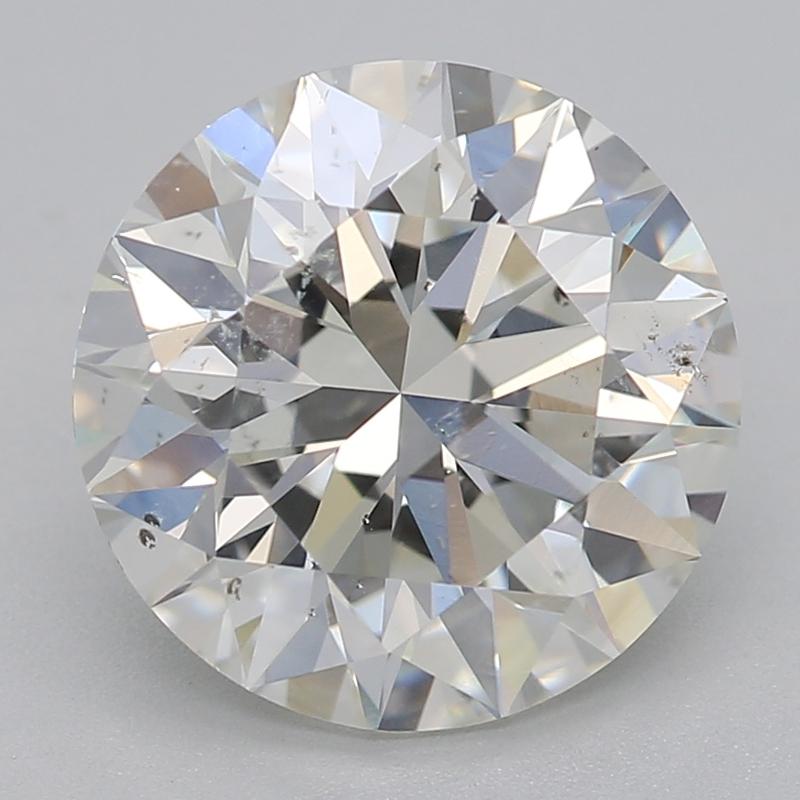 Handcrafted in New York, this stunning diamond ring features a captivating round 2.20 center stone, showcasing an impressive balance of size and sparkle. Set in a secure four-prong configuration, the centerpiece is crafted to highlight its beautiful