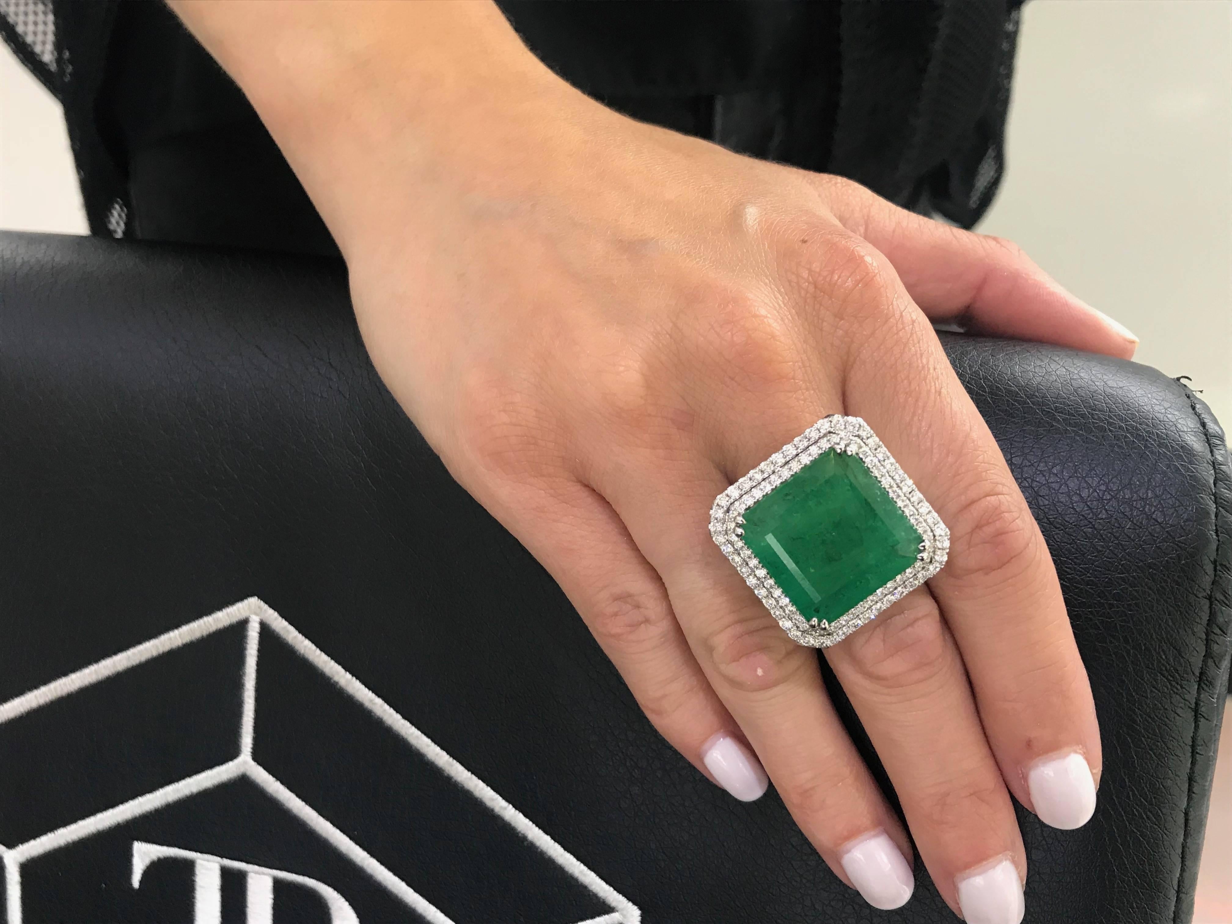 A magnificent GIA Certified 22.23 Carats Octagonal Step Cut Green Emerald featuring a double halo of 2.00 Carat Color H Clarity SI1 Round White Brilliant Diamonds. Set in 18 Karat White Gold. UK size - N 1/2, USA - 7 1/2. This eye catching Ring can