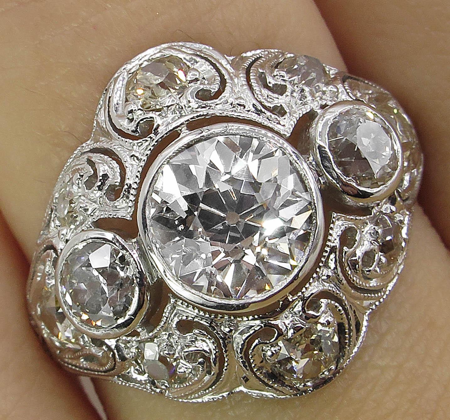 A Beautiful Antique Vintage Authentic Late Edwardian/ Early Art Deco Platinum (tested) dazzles Bezel set GIA Certified 1.19ct Old European Center diamond in J color and VS2 clarity (Near COLORLESS and VERY clear). The measurements of the Center are