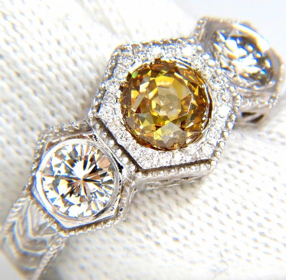 Edwardian Classic Threes

GIA Certified: 1.36Ct Natural Fancy Yellow Brown European cut round diamond ring.

Report # 2155624773

Stating: Fancy Brownish Yellow 

Si-1 clarity. 

(No visible black inclusion).



.84ct. Side round (2) cut diamonds

&
