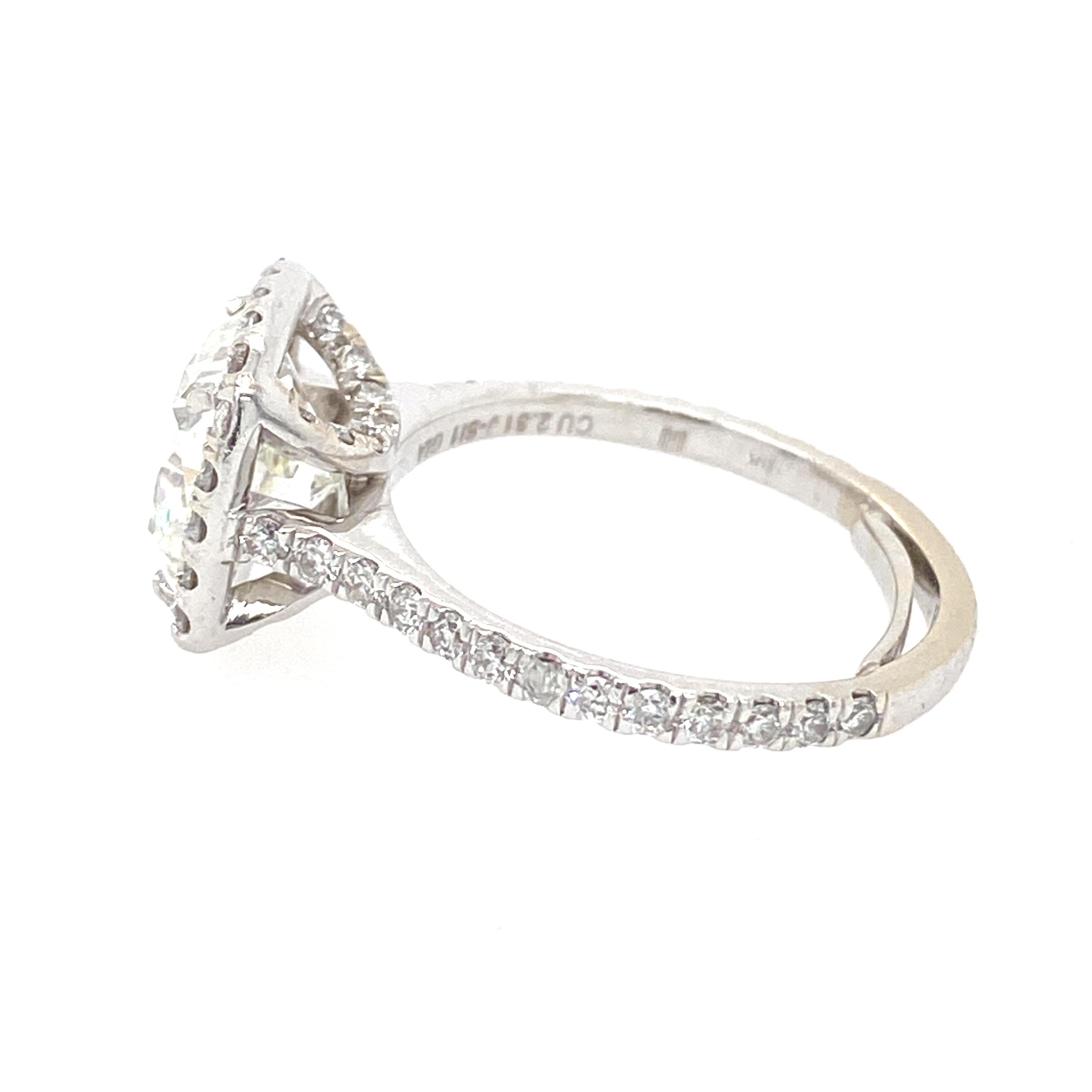 The center diamond is a GIA 2.31 J color SI1 clarity cushion cut. There are .89cts of brilliant cut diamonds around the center stone and down the shank. The ring is in 18K white gold. Ring size 5.5 and can be sized. 