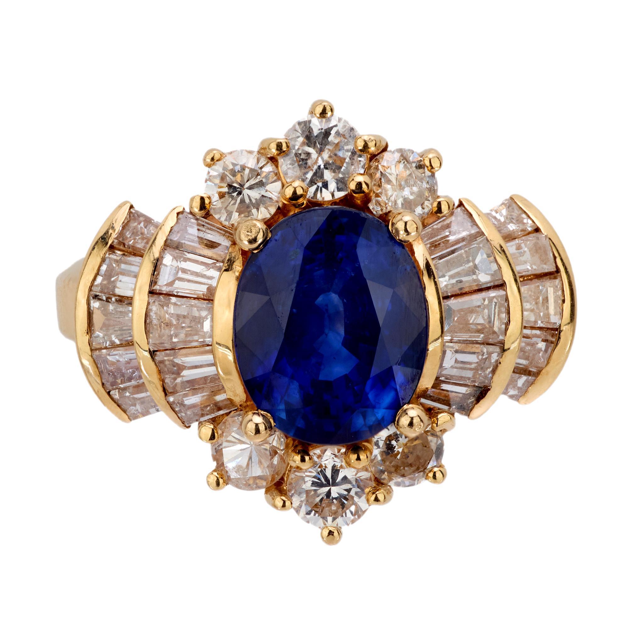 Crafted in the 1980s, this vintage cocktail ring features a GIA-certified 2.35-carat oval cut blue sapphire from Ceylon, enhanced with heat treatment to deepen its rich hue. Surrounding the center stone are 26 round brilliant and baguette cut