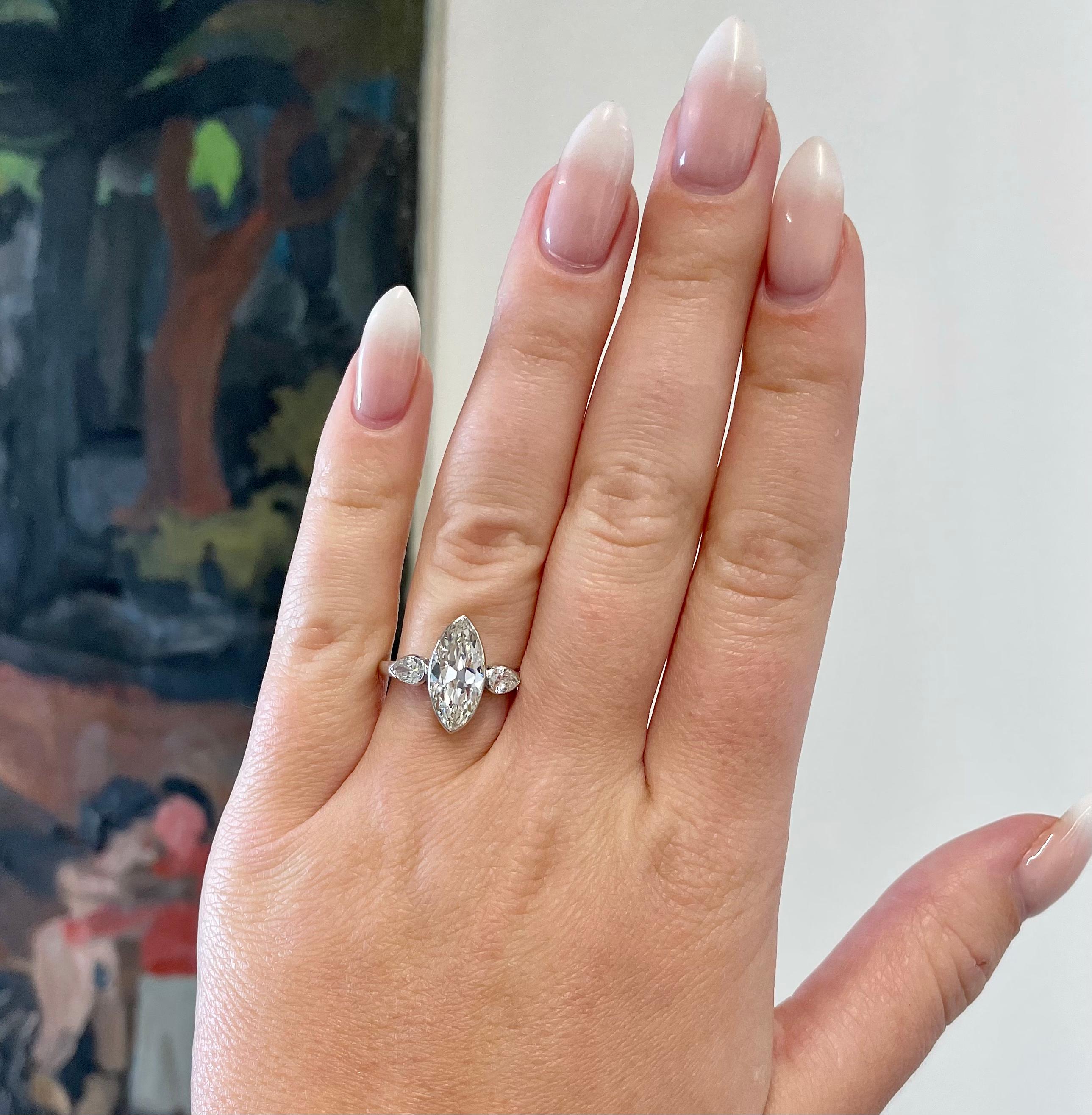If you are looking for an engagement ring full of character, consider this striking GIA 2.36 Carat Marquise Cut Diamond Platinum Three Stone Engagement Ring. A timeless design that will make you stand out from the crowd. 

The center diamond is a